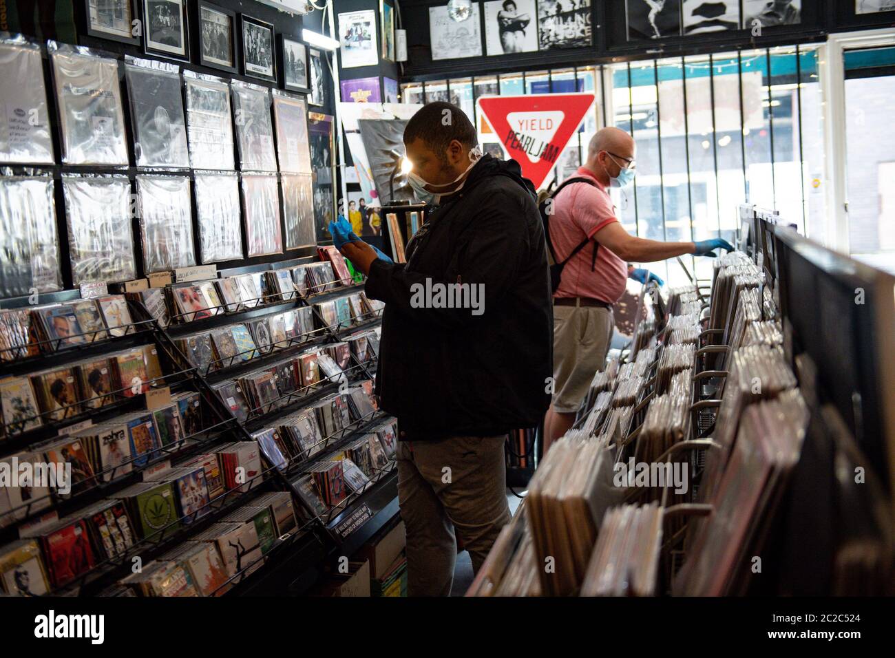 Ein Mann trägt Handschuhe, als er sich auf den Einkauf bei Swordfish Records in Birmingham vorbereitet, da weitere Beschränkungen für die Sperrung von Coronaviren in England aufgehoben werden. Stockfoto