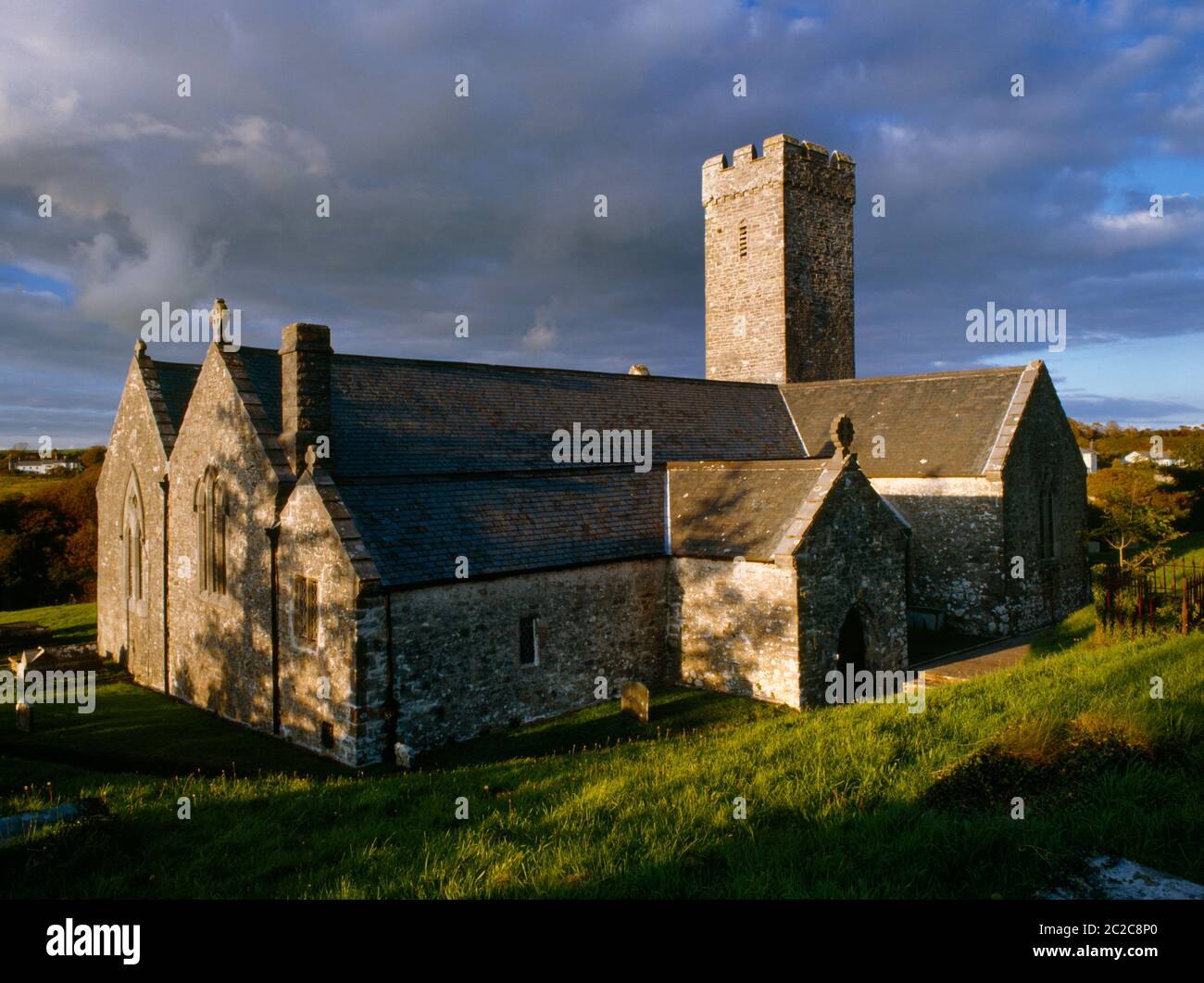 Abendansicht der St James' Church, Manorbier, Pembrokeshire, Wales, UK, Blick nordöstlich auf das Normannische Kirchenschiff mit C13th Chancel, C14th Gängen, & Turm im Nordosten. Stockfoto