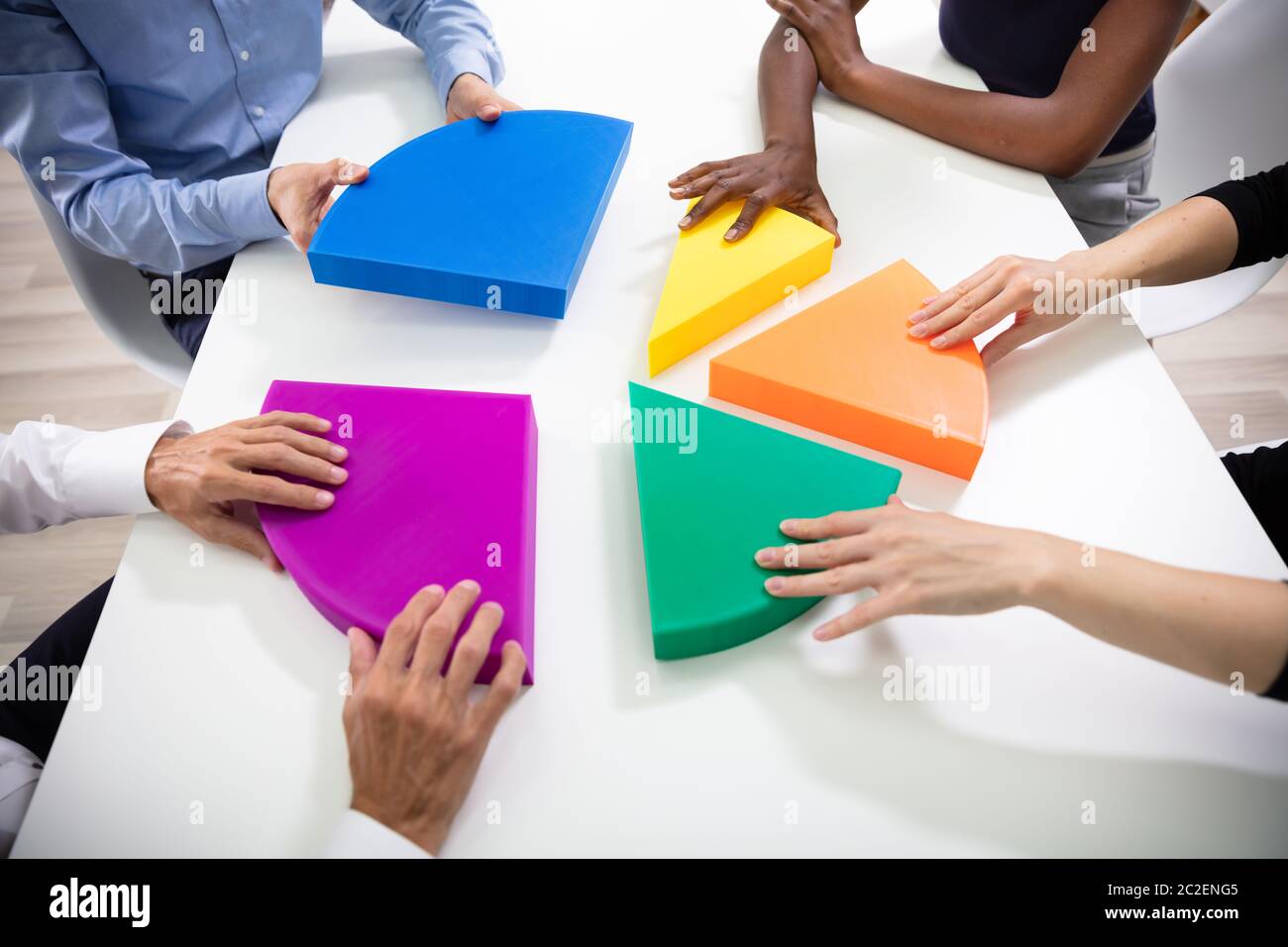 Hohe Betrachtungswinkel der Geschäftsleute Hände Mit Bunten Stücke des Kreisdiagramms Stockfoto