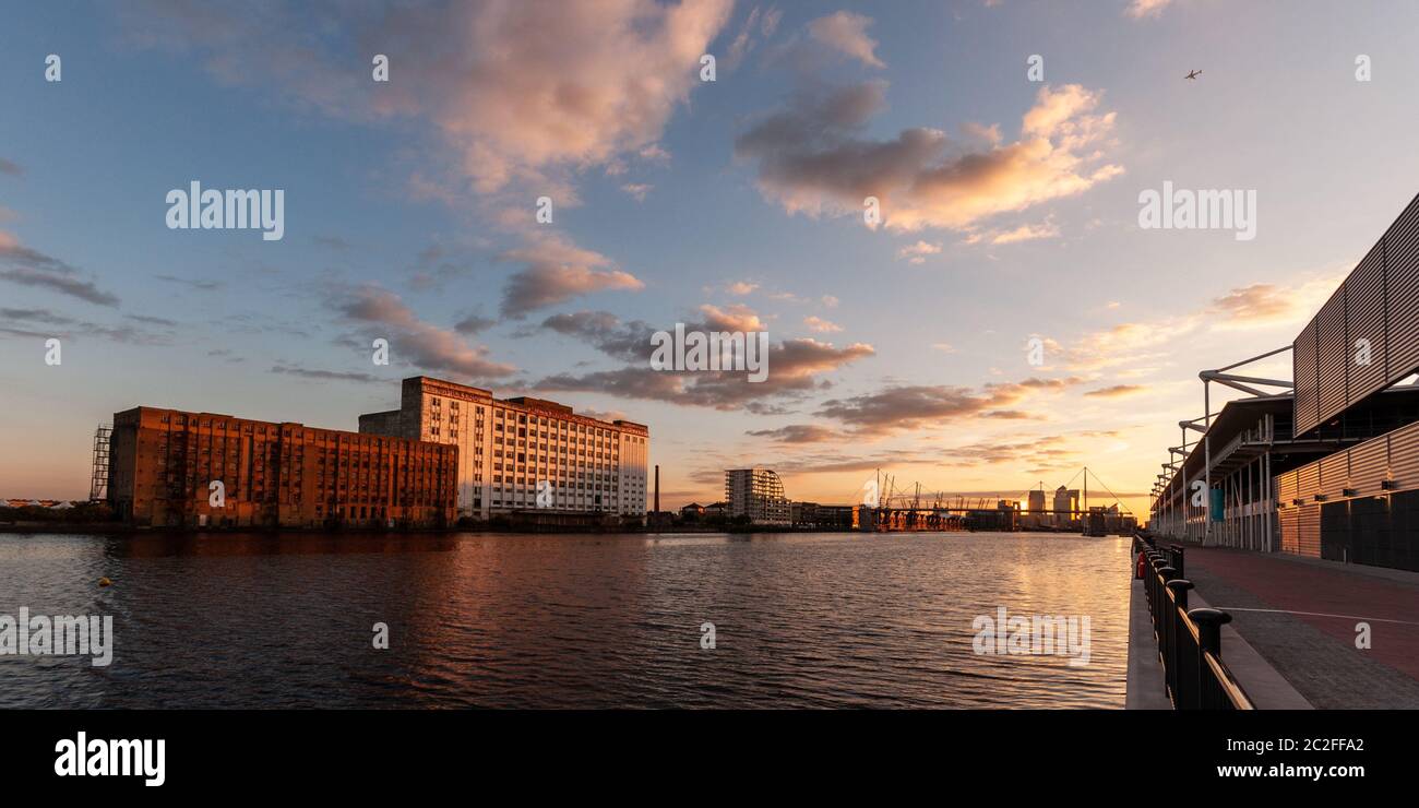 London, England, Großbritannien - 31. Juli 2010: Der Sonnenuntergang wirft einen Schein über die Millennium Mills und Excel Gebäude am Royal Victoria Dock im Osten Londons Stockfoto