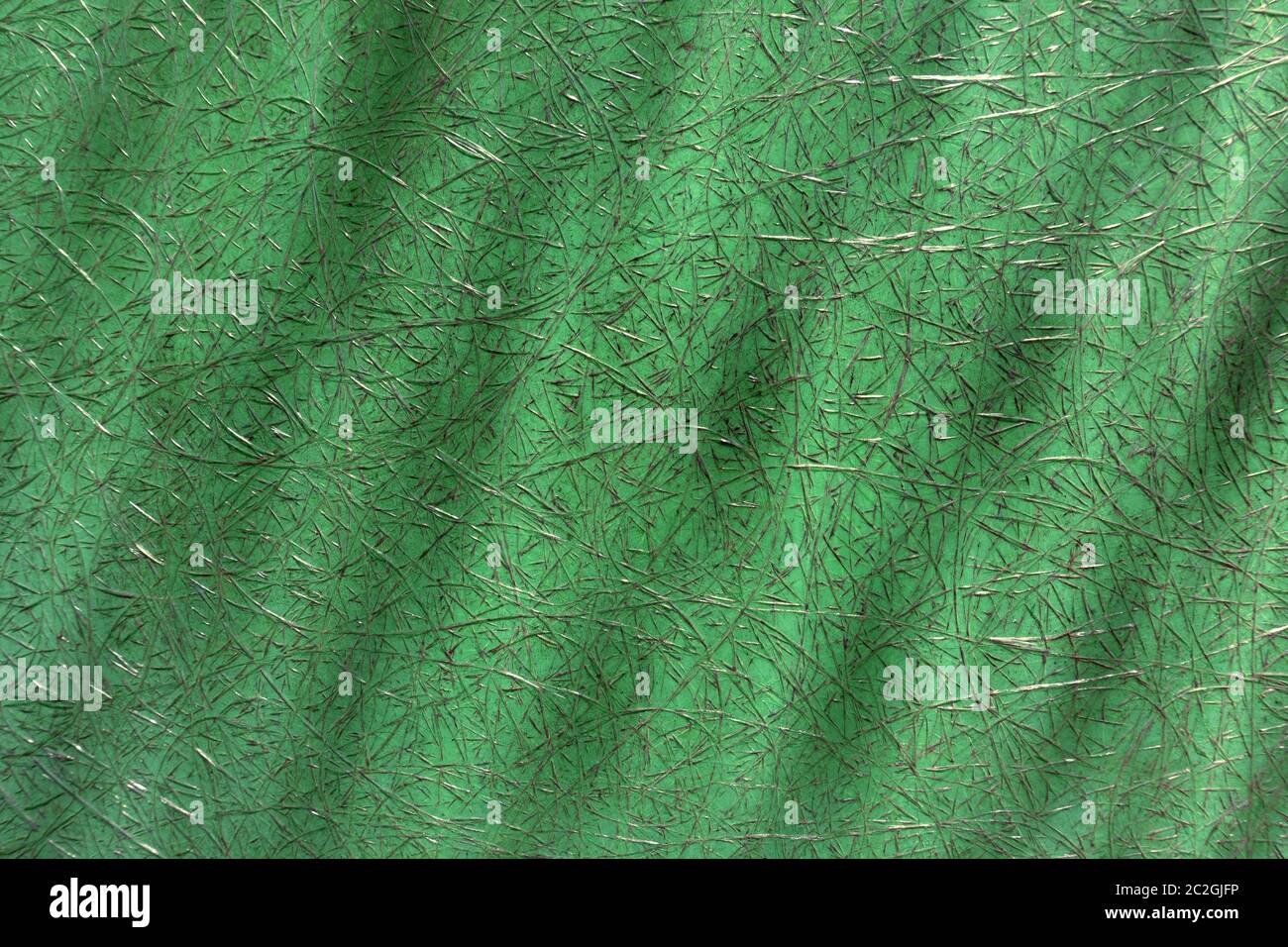Grüner abstrakter Kunststoff mit Fiberglas und dunklen Flecken in Nahaufnahme Stockfoto