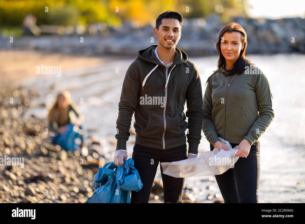 Junge ernsthafte multi-ethnische Umwelt Freiwilligen stehen am Strand Stockfoto