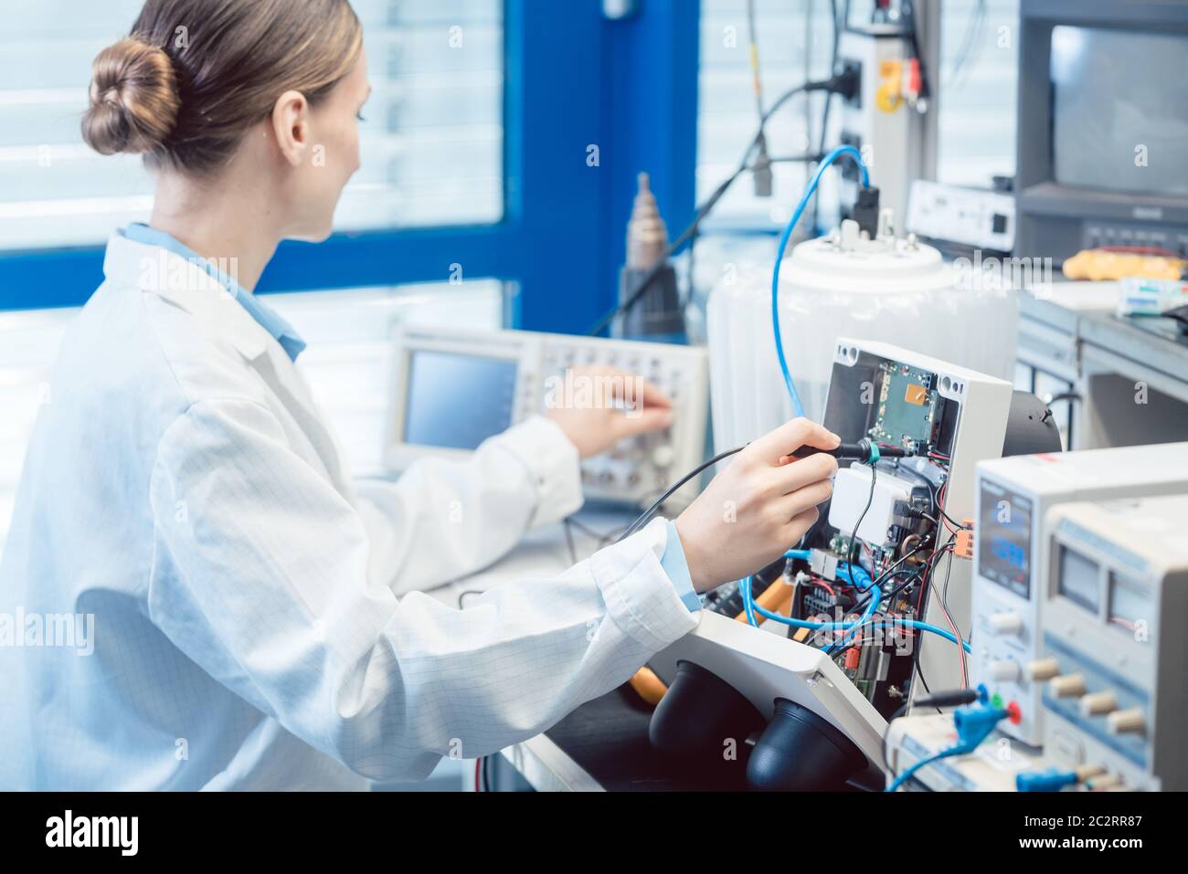 Ingenieurin Frau, die elektronische Produkte auf dem Prüfstand in ihrem Labor auf EMV-Konformität misst Stockfoto