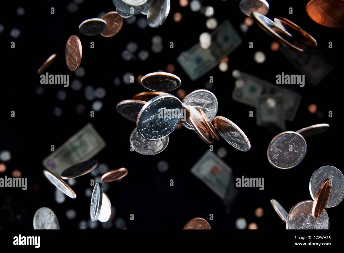 Fallende Münzen, die durch die Luft fliegen, repräsentieren Wirtschaft und Finanzen mit einem Nickel der Schwerelosigkeit als Schwerpunkt der Währung. Stockfoto