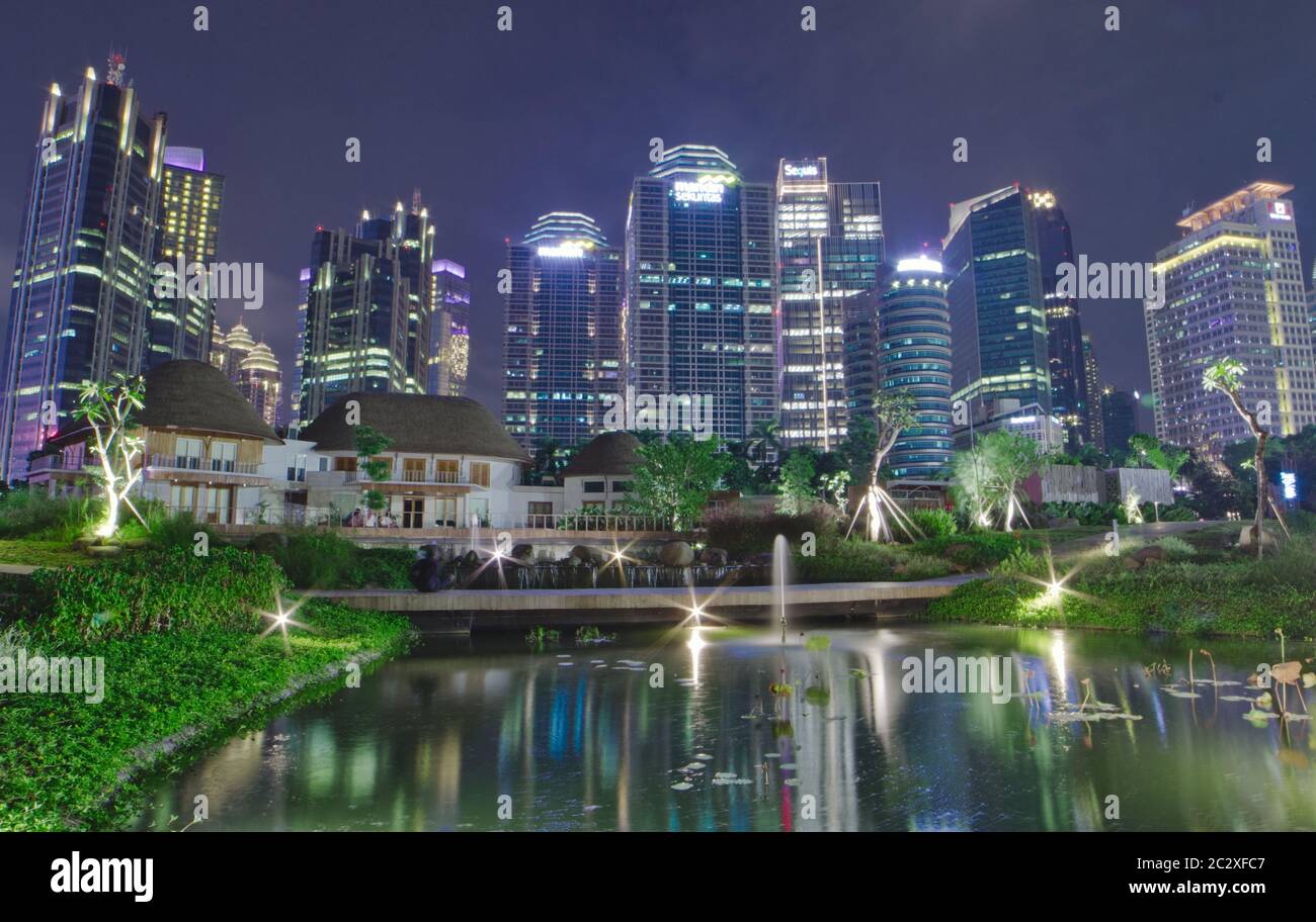 Skyline von Downtown Jakarta mit Blick auf das Grün und Fluss in der Nacht Stockfoto