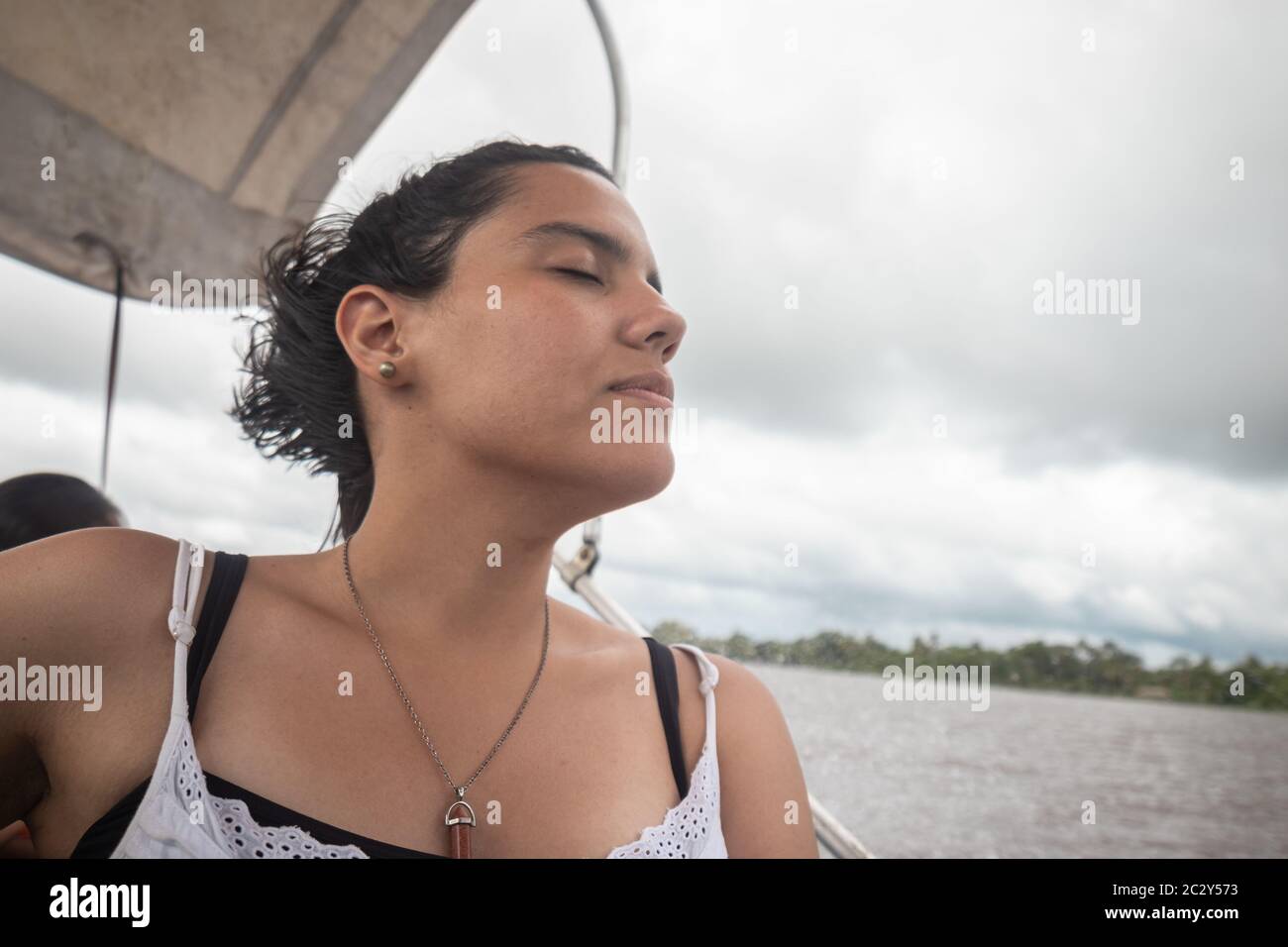Frau findet sich mit geschlossenen Augen auf eine Sportart Boot während cruisi Stockfoto