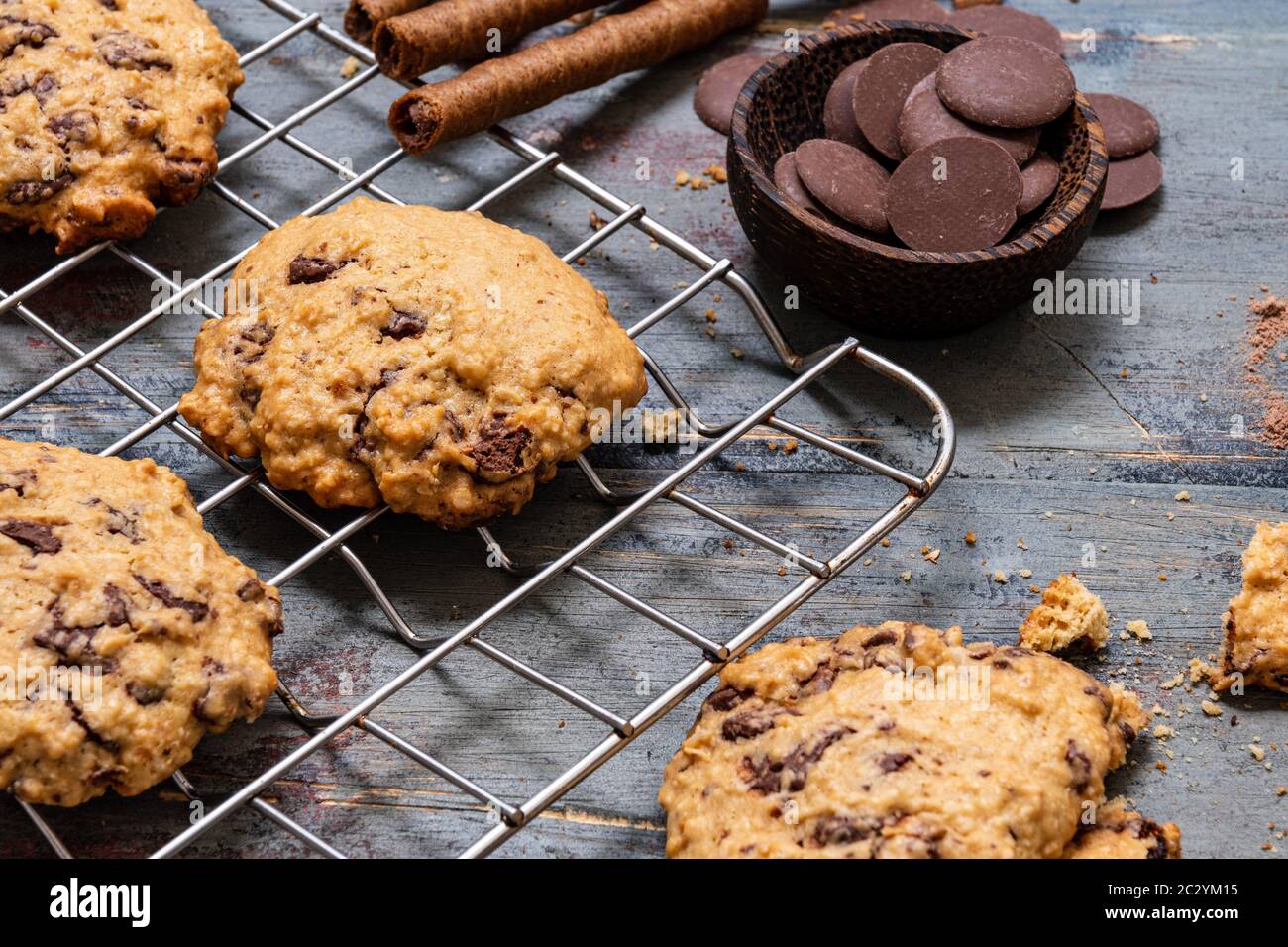 Schokoladenkuchen, auf rustikalem Holz neben Kakao in verschiedenen Formen Stockfoto