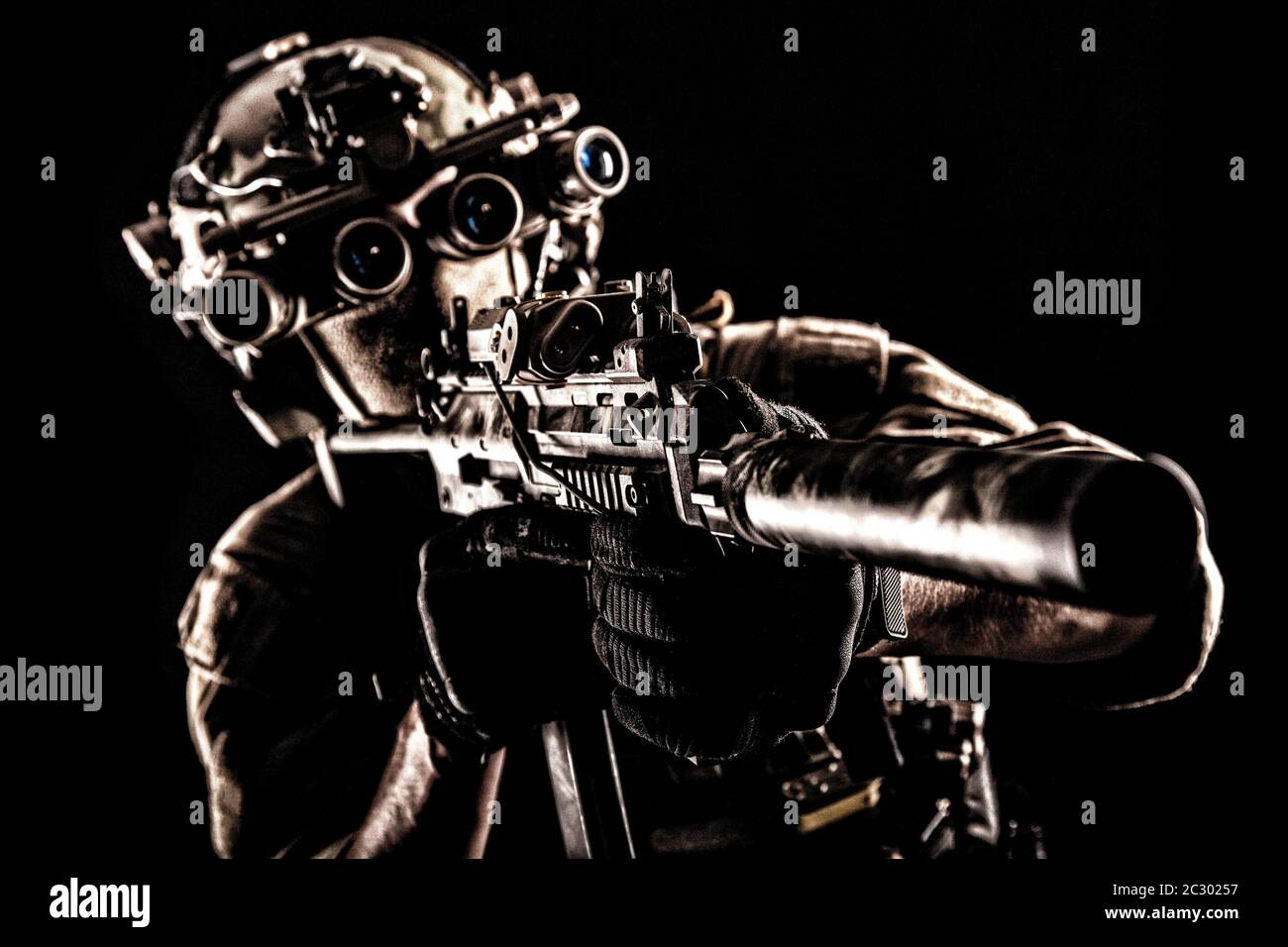 Army Special Operations Soldat, Commando fighter in voller taktischer Munition, Helm mit Radio Headset und Nachtsichtgerät, mit dem Ziel, kurze Lauf Stockfoto