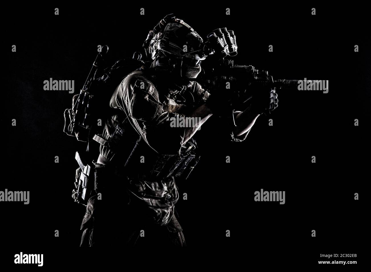 Army Special Operations Soldat, Commando fighter in voller taktischer Munition, Helm mit Radio Headset und Nachtsichtgerät, mit dem Ziel, kurze Lauf Stockfoto