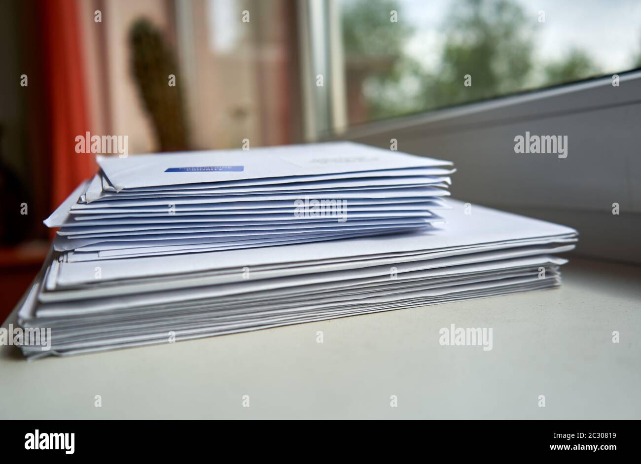 Stapel von Umschlägen in der Nähe des Fensters Stockfoto
