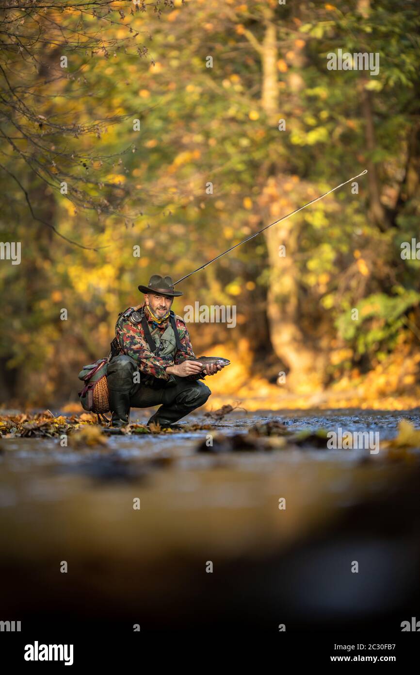 Nahaufnahme der Hände von einer Fliege Fischer Holding eine schöne Forellen beim Fliegenfischen auf einem herrlichen Berg River Stockfoto