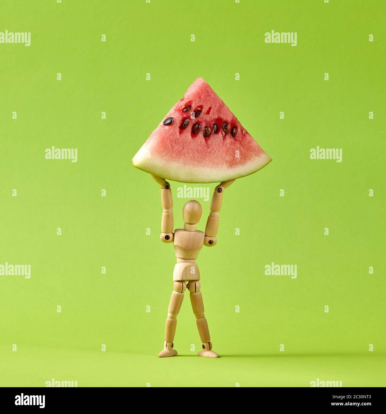 Energie wooden mannequin Modell hält Stück reife Wassermelone  Stockfotografie - Alamy