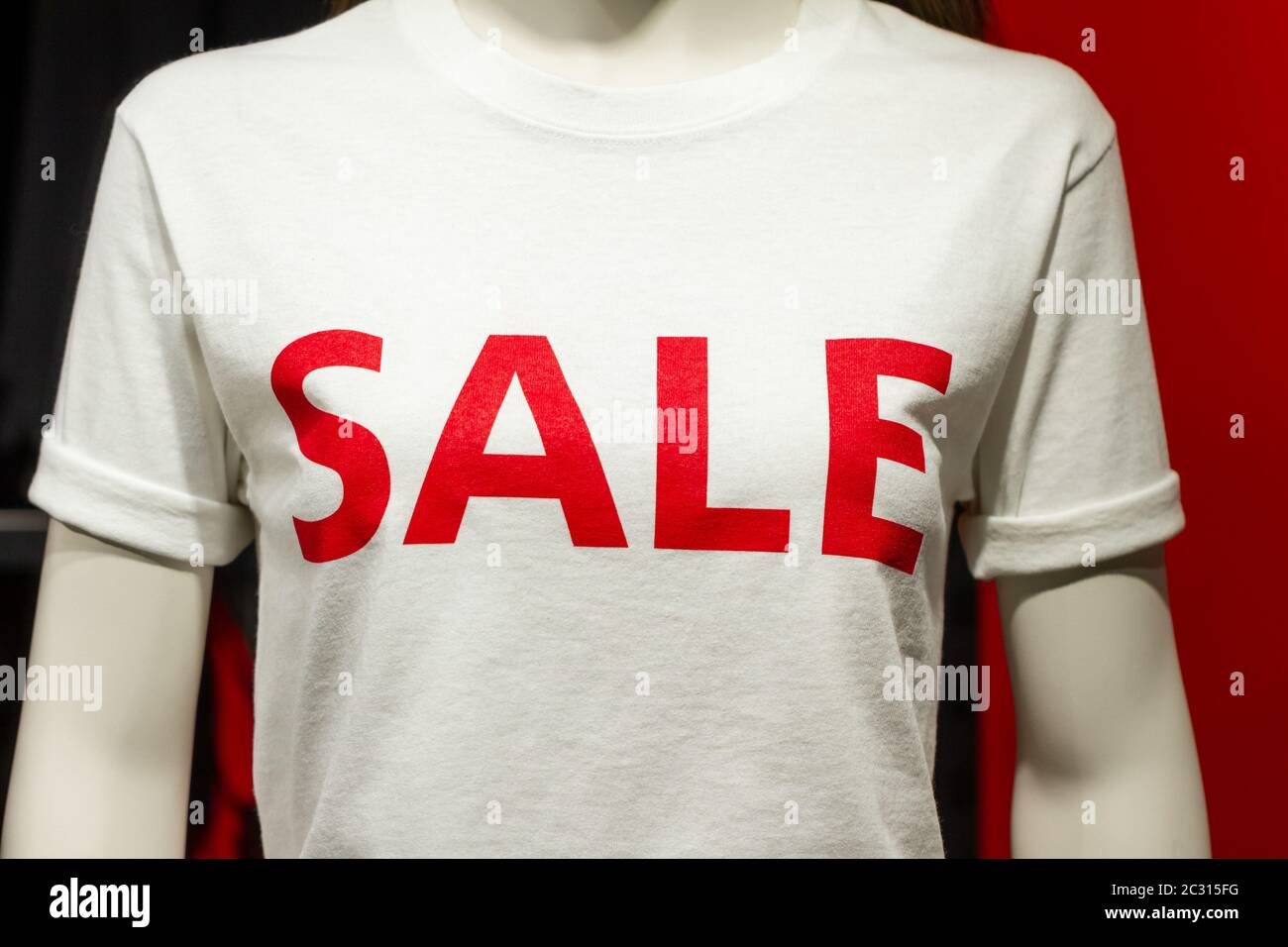 Weibliche Oberkörper dummy in einem Shop Display mit dem Wort VERKAUF darauf geschrieben. Konsumismus und der niedrige Preis. Stockfoto