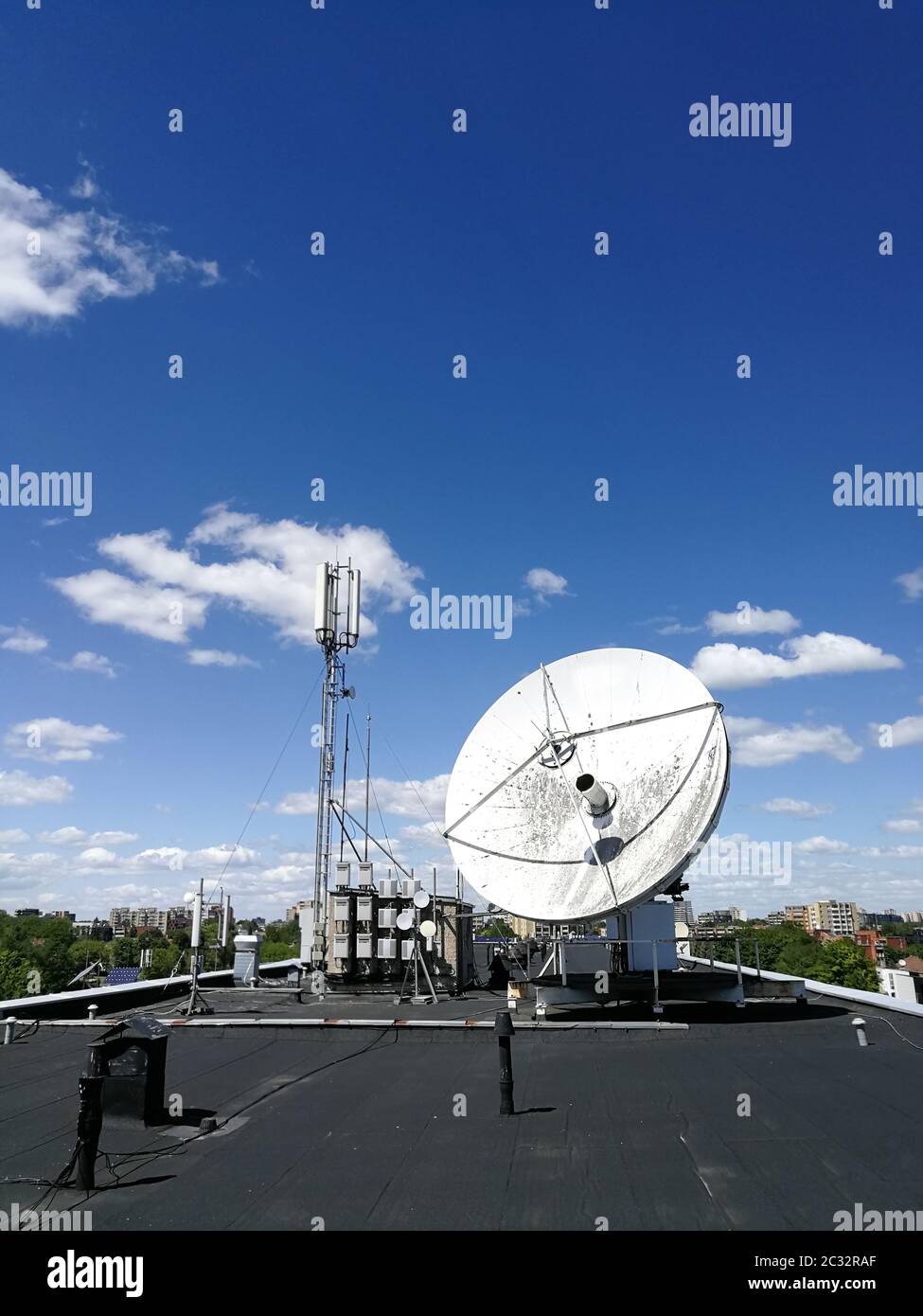 Riesige Retro-Satelliten Parabolantenne auf dem Dach für High-Speed-Internet-Verbindung vor blauem Himmel Stockfoto