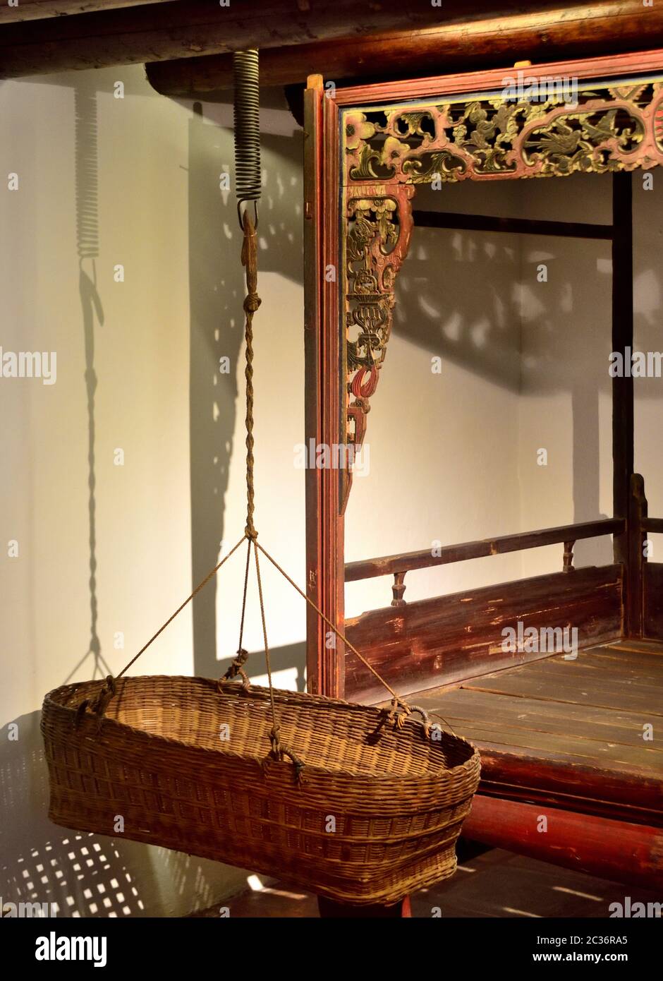 Traditionelle Wiege aus Rattan im chinesischen Stil, Sam Tung UK Museum, Tsuen Wan, Hongkong. Stockfoto