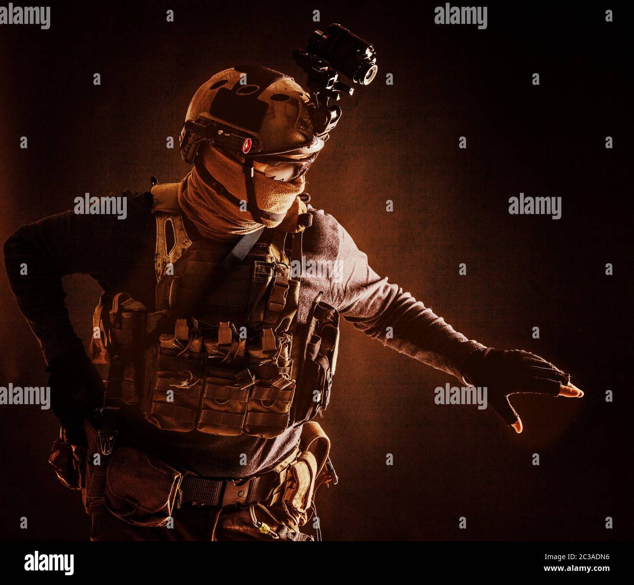 Spezialoperationen Kämpfer im Helm mit Nachtsicht, Wärmebildgerät, Ladungsträger vorsichtig bewegen mit Vorsicht in der Dunkelheit, Hand o halten Stockfoto