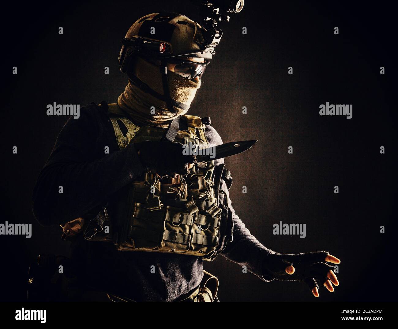 Spezialoperationen Soldat, Kommandojäger, moderner Kampfkämpfer in Kampfuniform, Helm mit Nachtsicht, Maske und Brille tragen, schleichen Stockfoto
