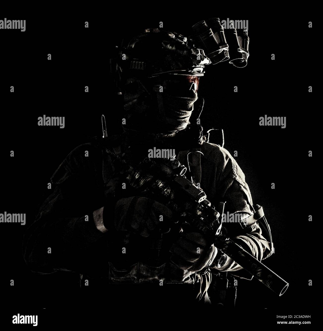 Armee Spezialoperationen Kräfte Soldat in Maske und Kampf Uniform, Helm ausgestattet Nachtsichtgerät, bewaffnete Maschinenpistole mit Schalldämpfer, suchen wie Stockfoto