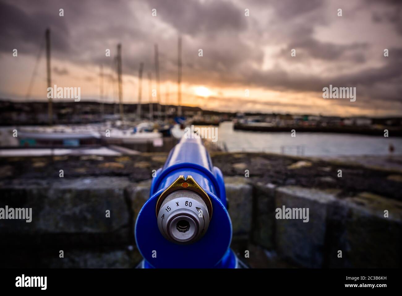 Selektiver Fokus auf blaues Teleskop am Hafen von Howth mit verschwommenem Hintergrund Stockfoto