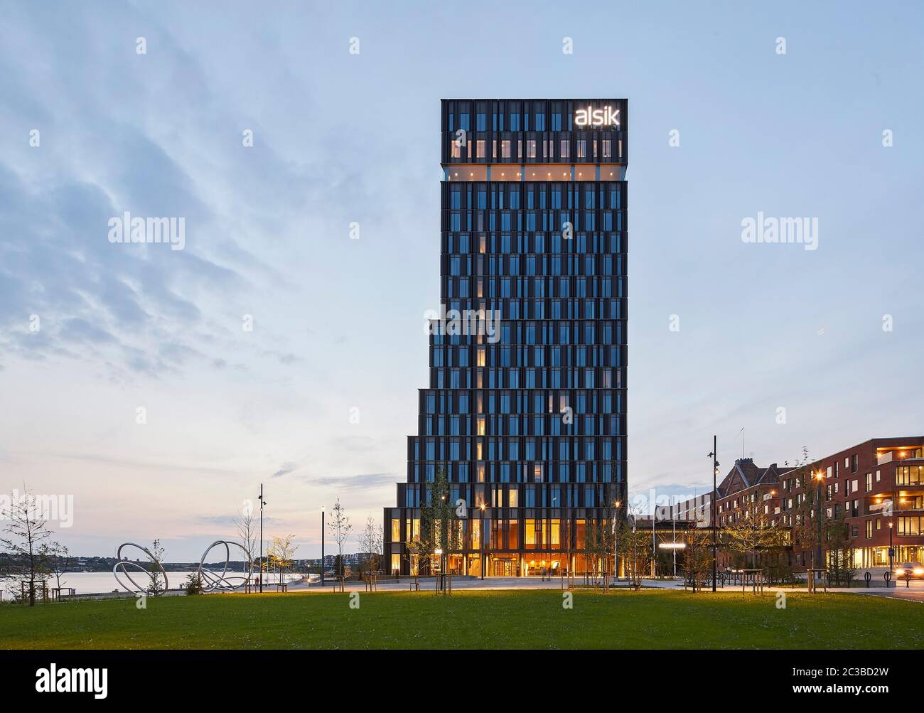 Kontextbezogene Ansicht von Süden bei Dämmerung. Hotel Alsik, Sønderborg, Dänemark. Architekt: Henning Larsen, 2019. Stockfoto