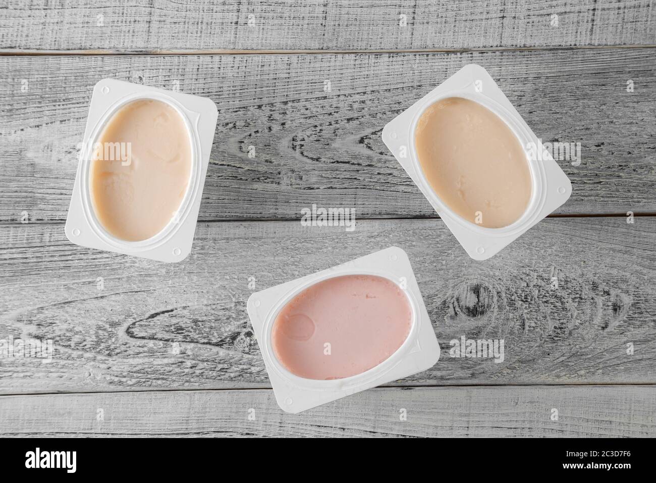 Natur-Bio-Joghurt verschiedener Art auf Holzgrund. Draufsicht Stockfoto
