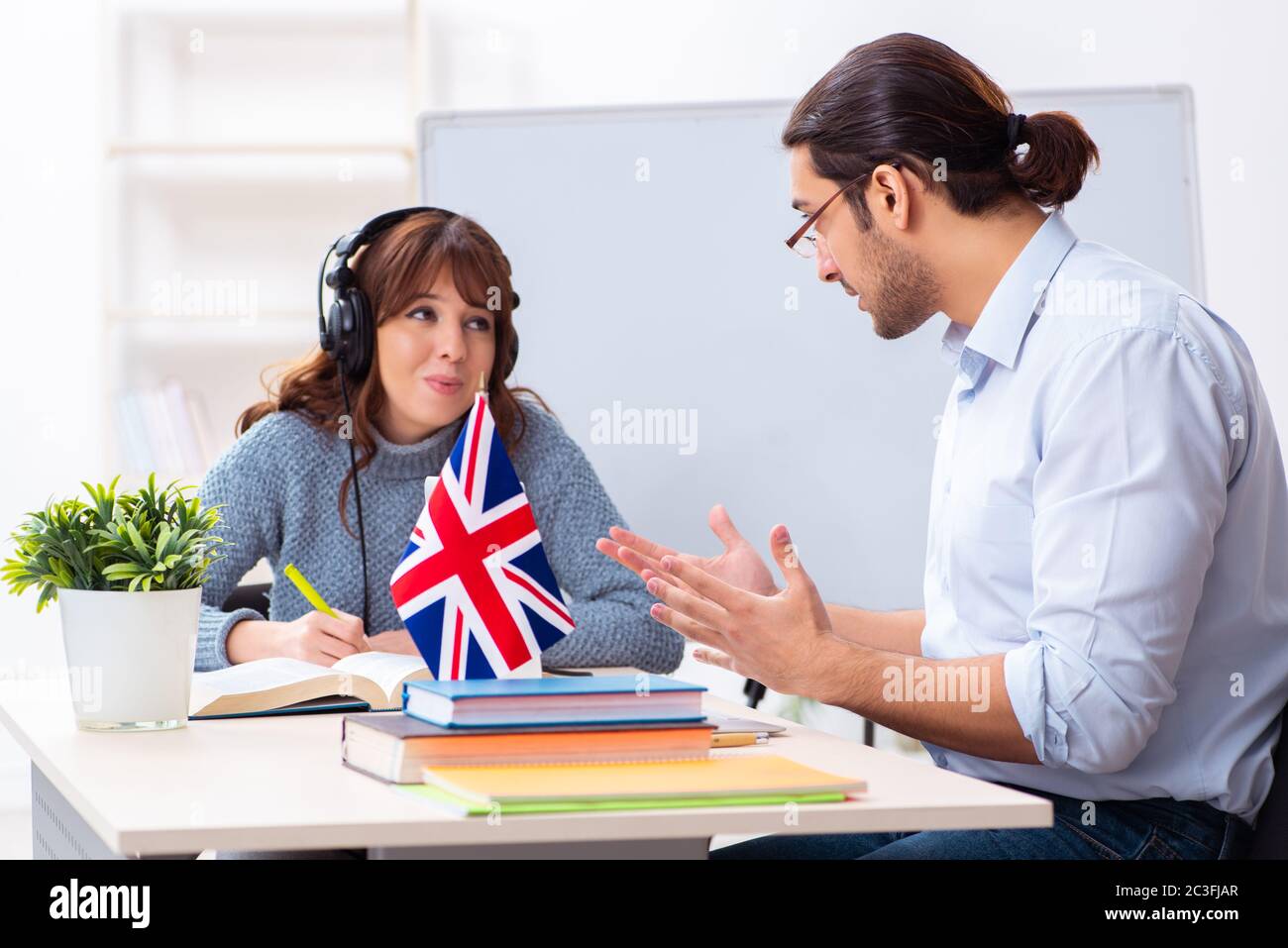 Junge Schülerin und Englischlehrerin im Klassenzimmer Stockfoto