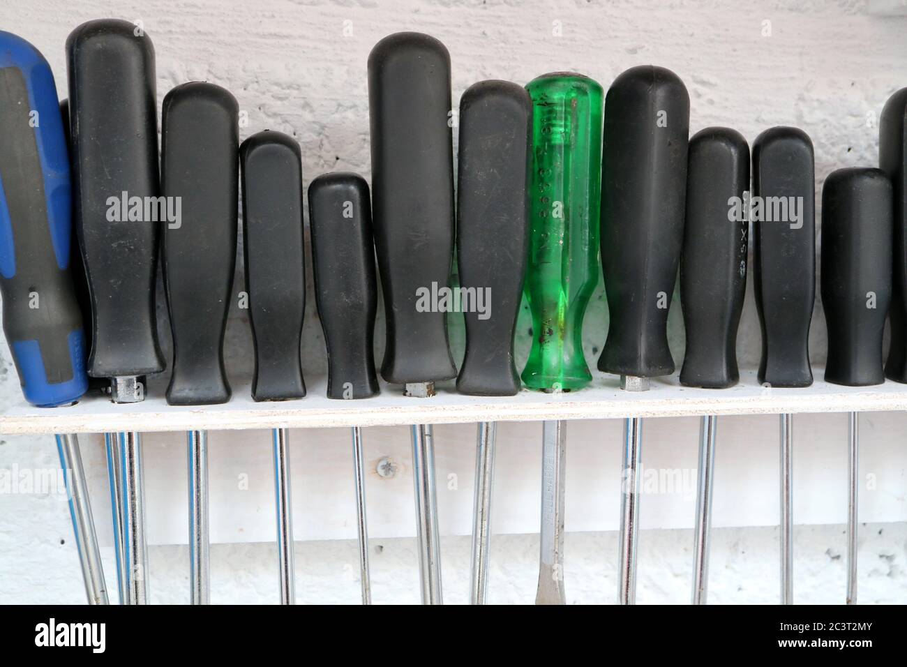 Reihe von Schraubendrehern auf selbstgemachten Rack in einer Werkstatt Stockfoto