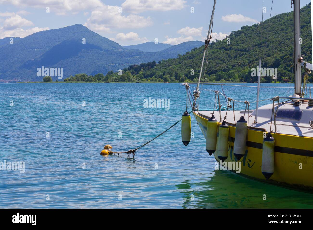 Ein gelbes Segelboot gegen den See iseo, Italien Stockfoto