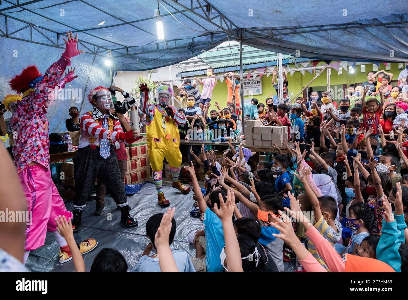 Jakarta, Indonesien. Juni 2020. Die Gemeinschaft „Aku Badut Indonesia“ (Ich bin indonesischer Clown) unterhält eine Reihe von Kindern, die vom Feuer in der Siedlung in Jakarta, Indonesien, am 23. Juni 2020 betroffen sind. Die Aktivität zielt auf die Traumaheilung und eine Form der Pflege für Jakarta Feuer Opfer vor allem Kinder. (Foto: Evan Praditya/INA Photo Agency/Sipa USA) Quelle: SIPA USA/Alamy Live News Stockfoto