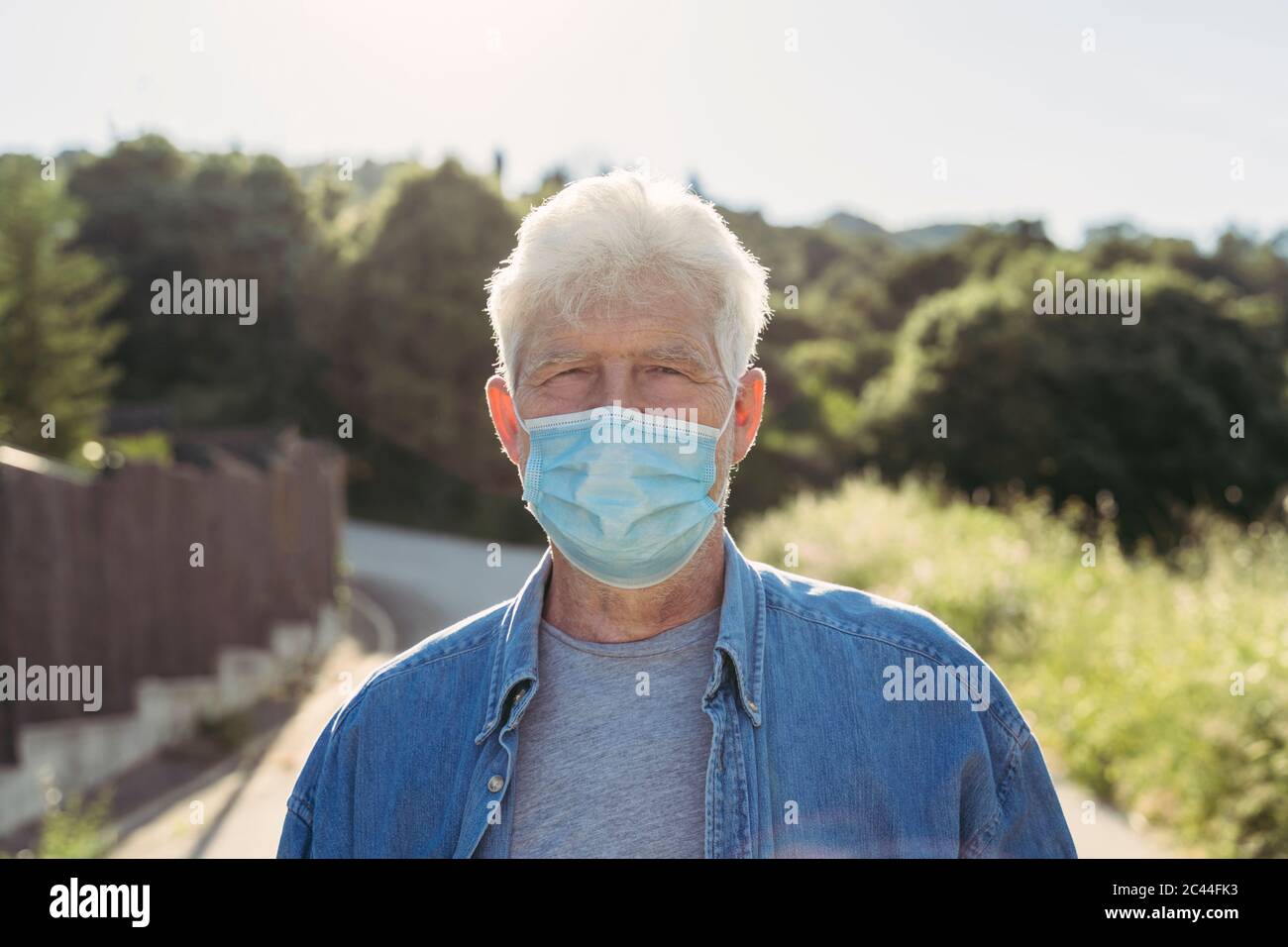 Älterer Mann mit Schutzmaske im Freien Stockfoto