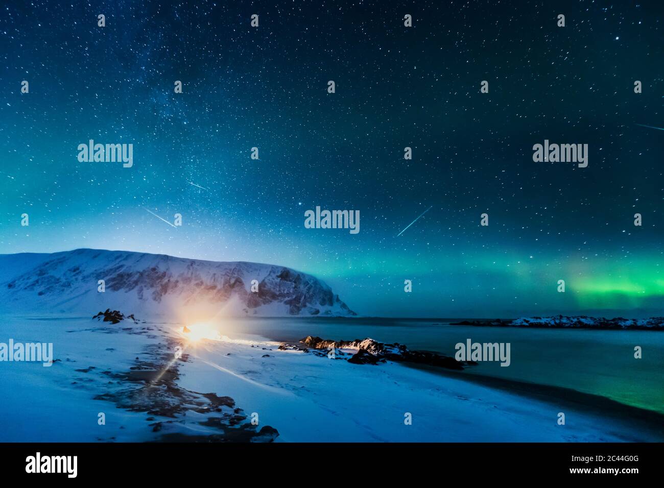 Nordlichter über dem Strand mit Lagerfeuer, Berlevag, Norwegen Stockfoto