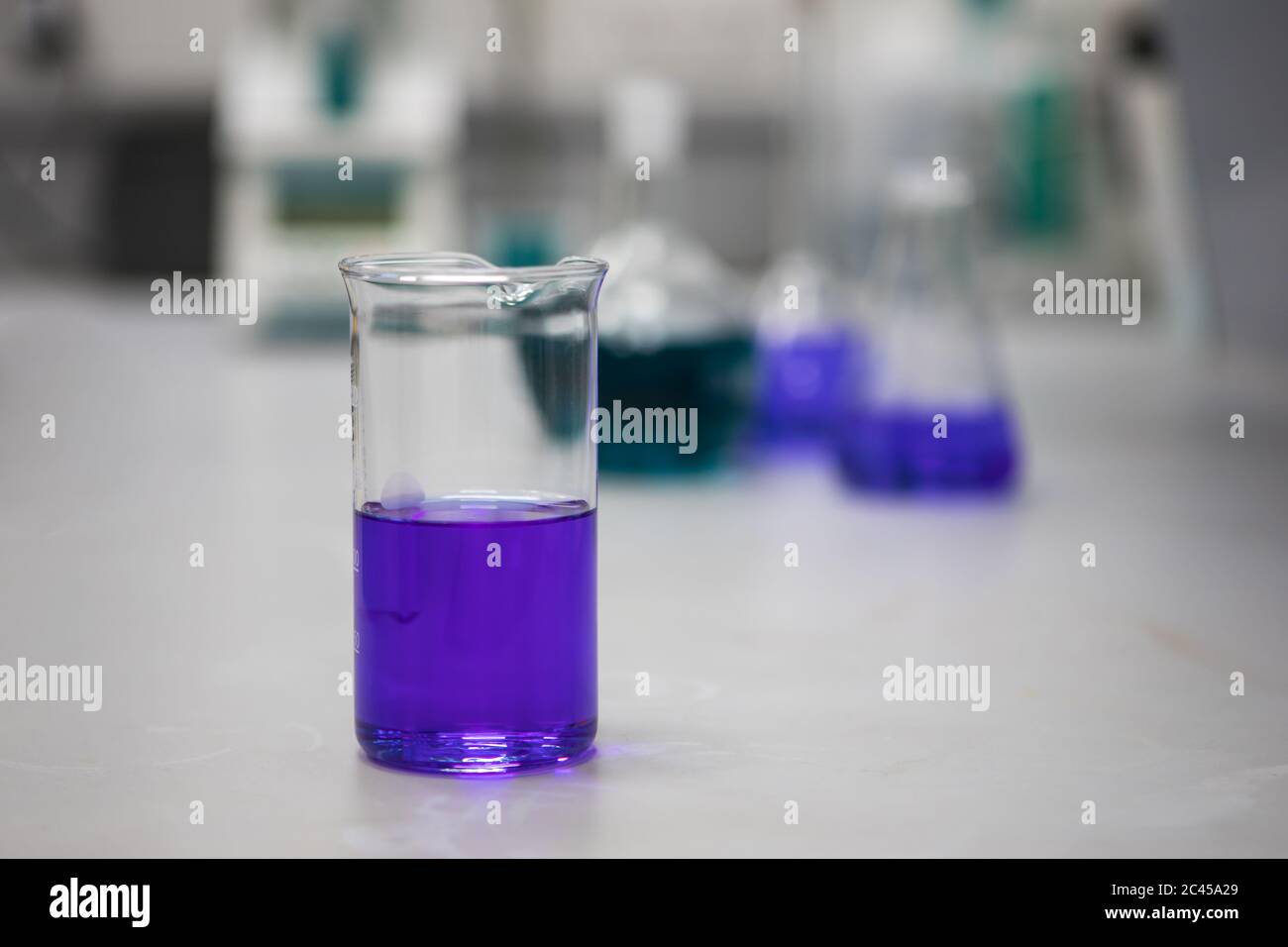 Lila chemische Lösungen in einem wissenschaftlichen Labor. Analytische Chemie Stockfoto