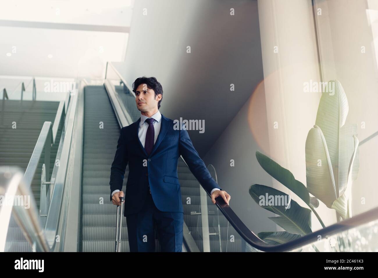 Geschäftsmann mit Rädern Gepäck auf hotel Rolltreppe Stockfoto