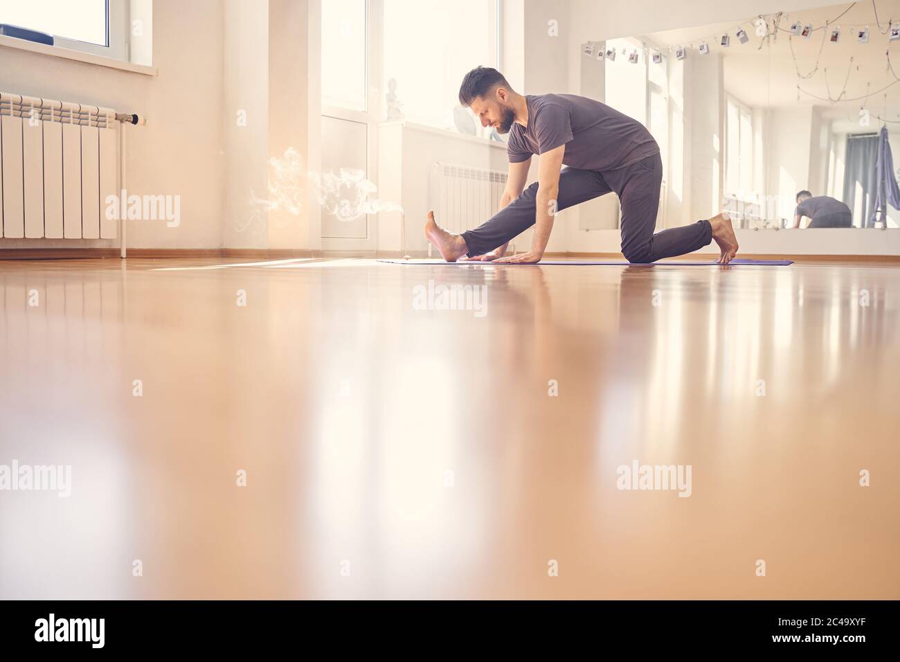 Bärtiger Mann, der Übung im Yoga-Studio macht Stockfoto