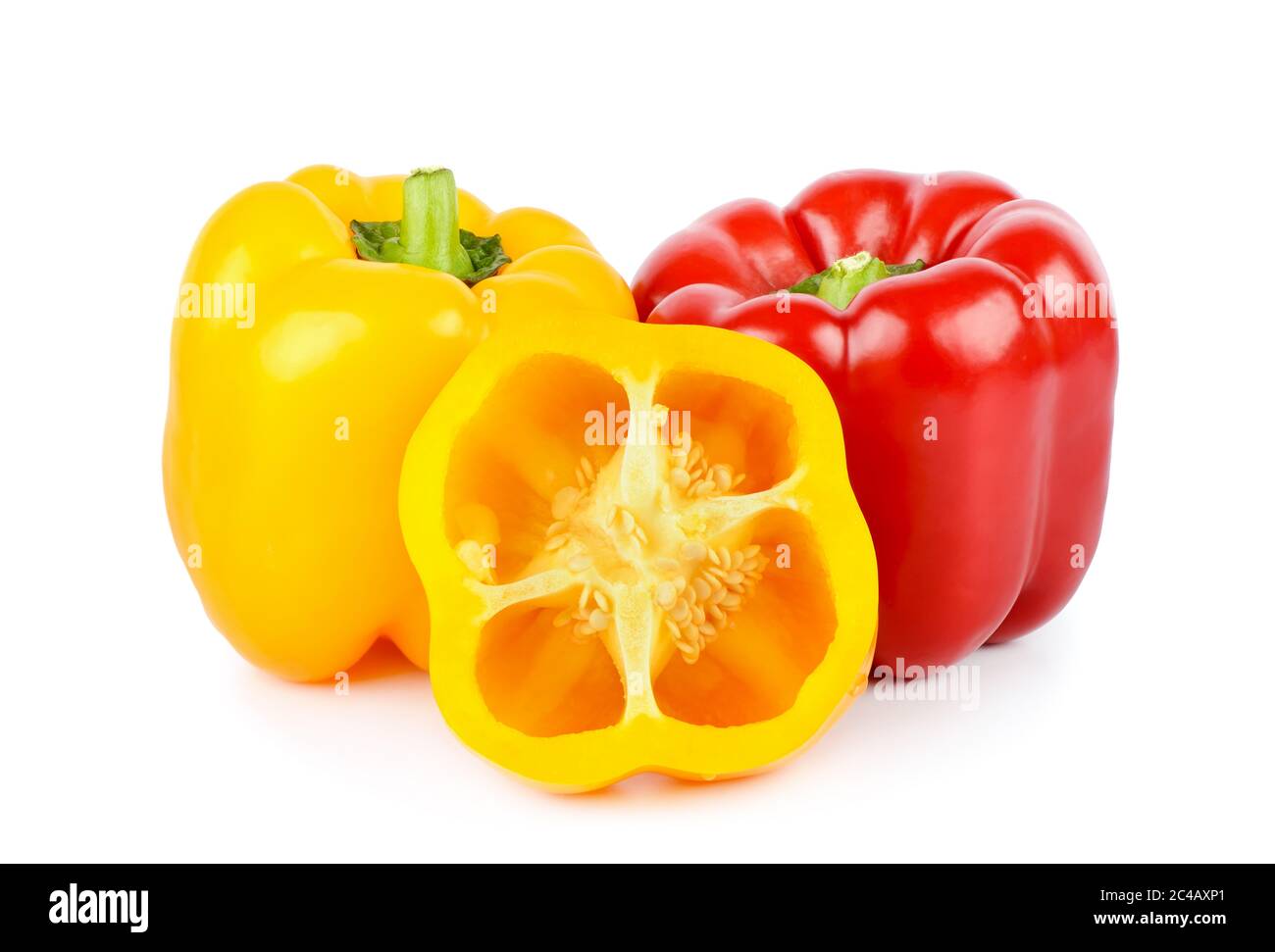 Ganze gelbe und rote Paprika und halb isoliert auf weißem Hintergrund. Stockfoto