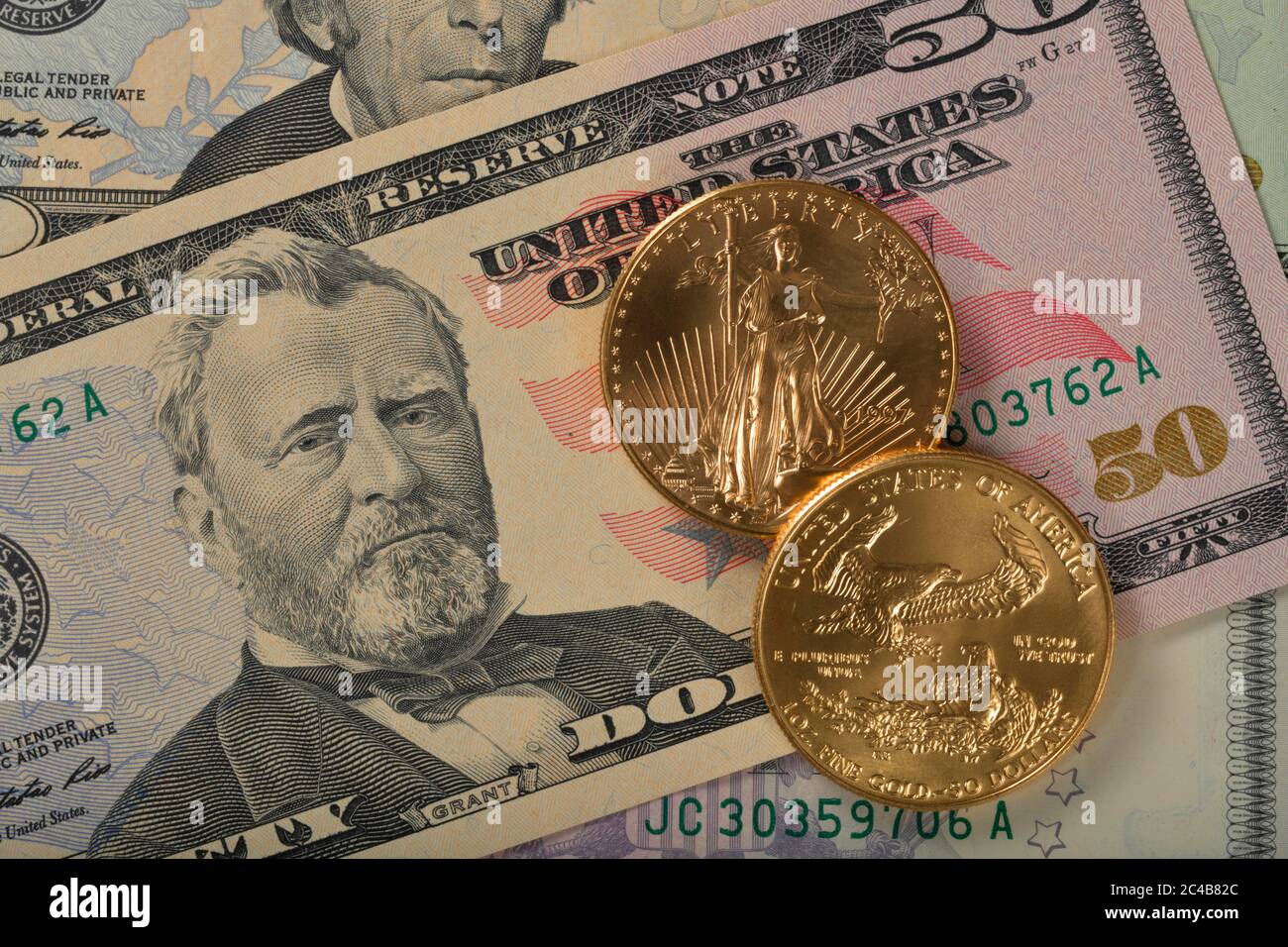 Physische Goldmünze 1 Unze American Gold Eagle Vorderseite und Rückseite Lady Liberty auf 50 US-Dollar Banknote Stockfoto