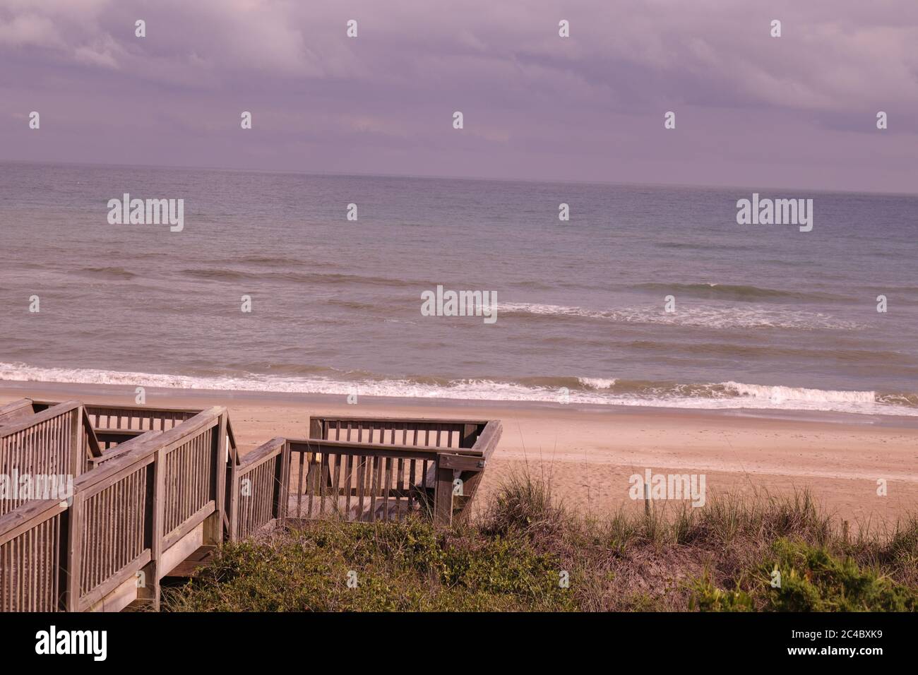 Eine Promenade an einem Strandhaus mit dem Atlantik im Hintergrund auf Emerald Isle, NC Stockfoto