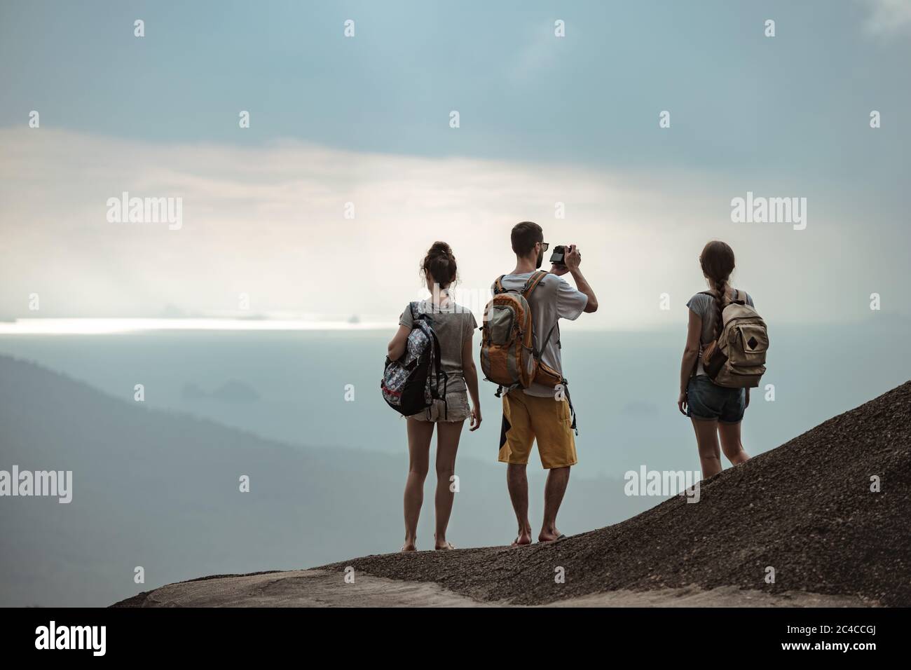 Drei junge Touristen entspannen und genießen am Meer Aussichtspunkt Stockfoto