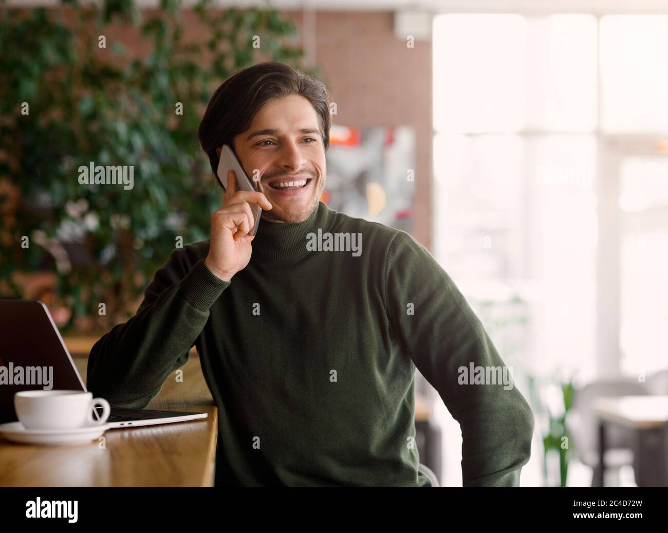 Wohlhabender junger Unternehmer mit Gespräch auf dem Smartphone Stockfoto