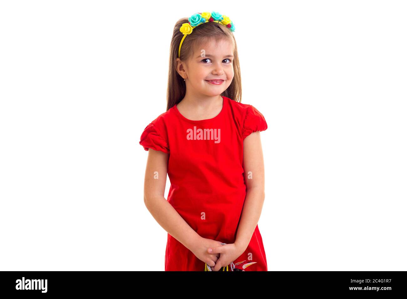 Kleines Mädchen in roten Kleid auf weißem Hintergrund. Stockfoto