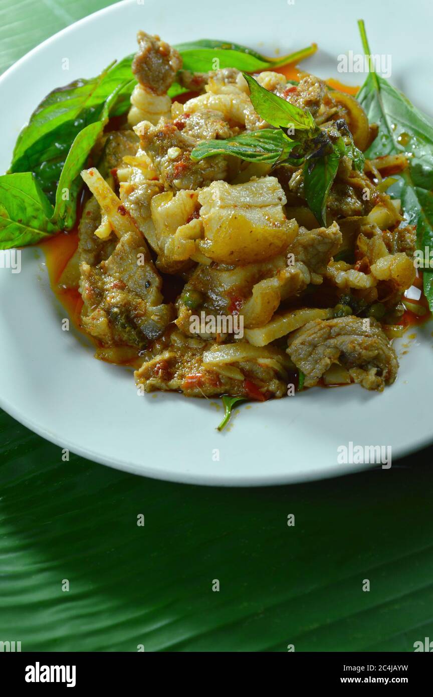 Gebratene würzige Wildschweine und Bambus schießen mit rotem Curry auf dem Teller rühren Stockfoto