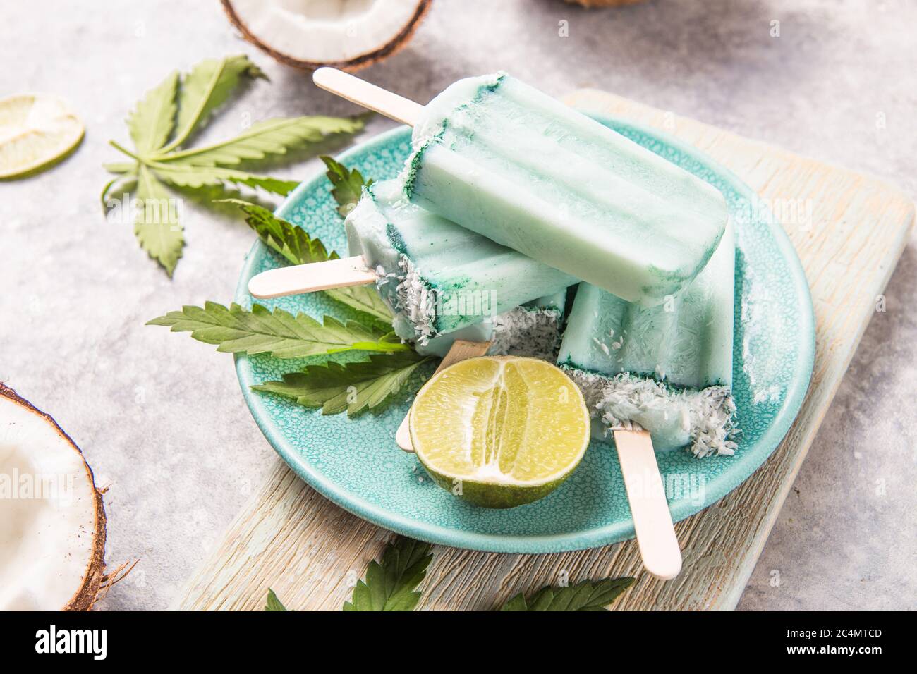 Eis-Eis-Eisdielen mit Kokosnussscheiben, Cannabis auf Betongrund. Stockfoto