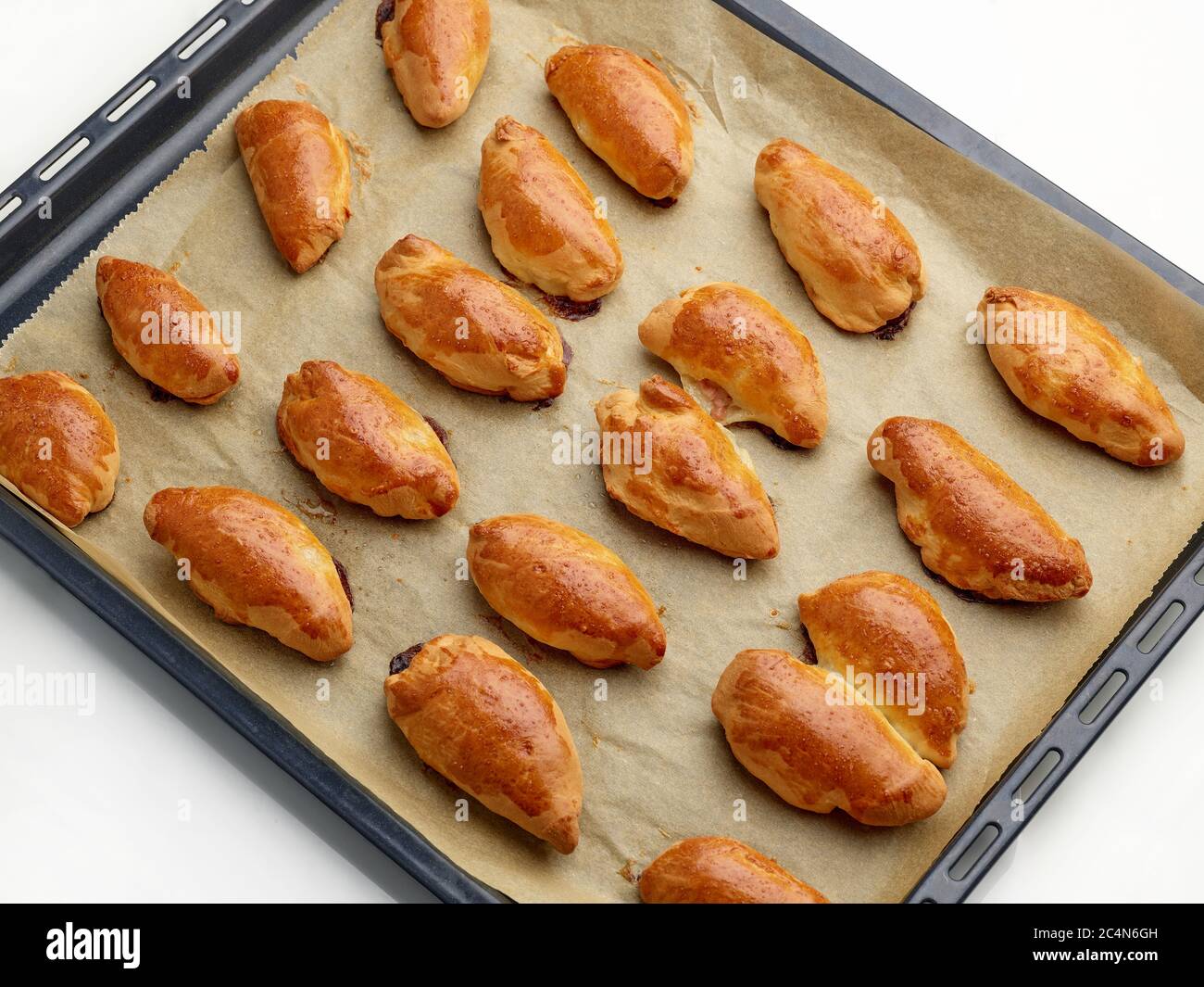 Frisch gebackene Fleischbrötchen auf Backpapier, Draufsicht Stockfoto