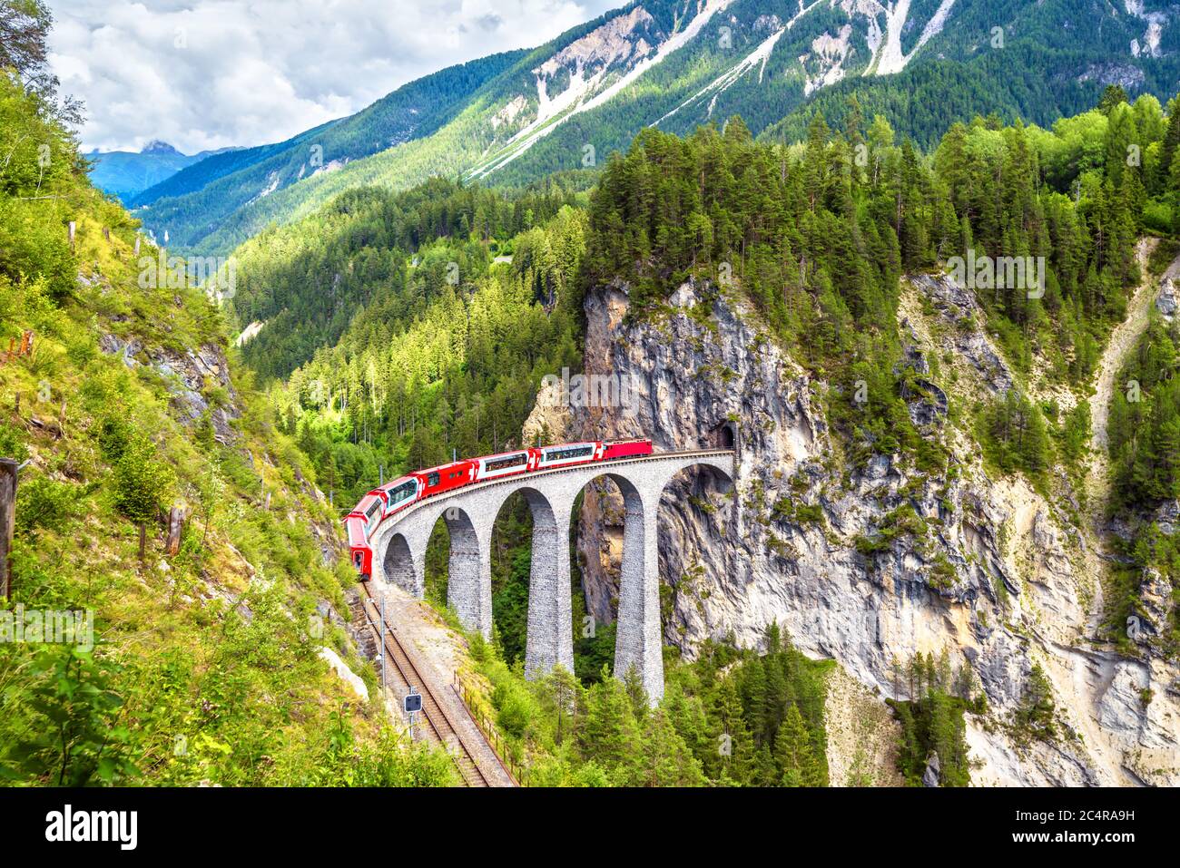Landwasser Viadukt im Sommer, Filisur, Schweiz. Es ist Wahrzeichen der Schweizer Alpen. Schöne alpine Landschaft. Roter Zug von Bernina Express auf der Brid Stockfoto