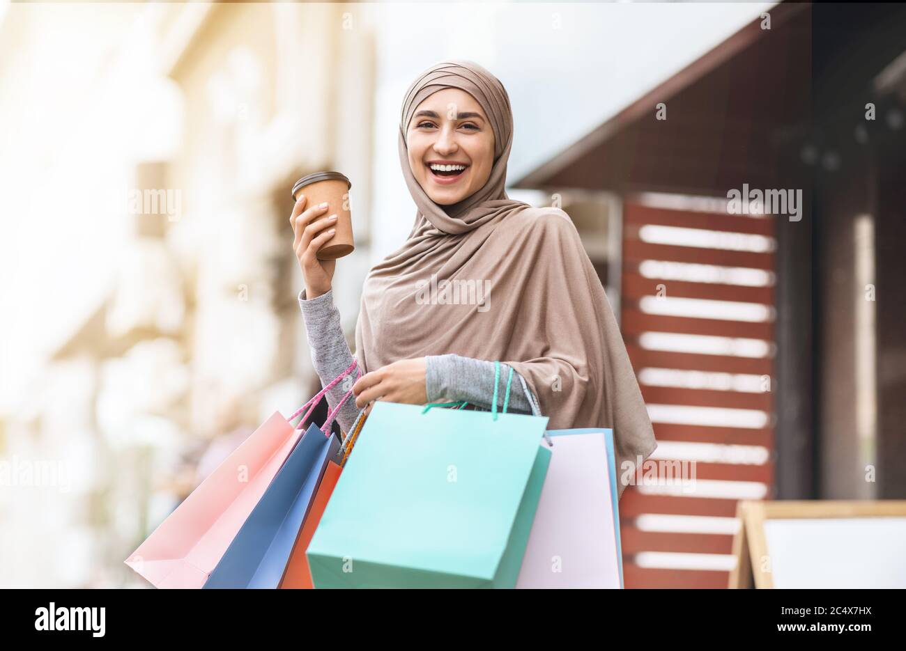 Schöne junge muslimische Frau mit Einkaufstaschen Stockfoto