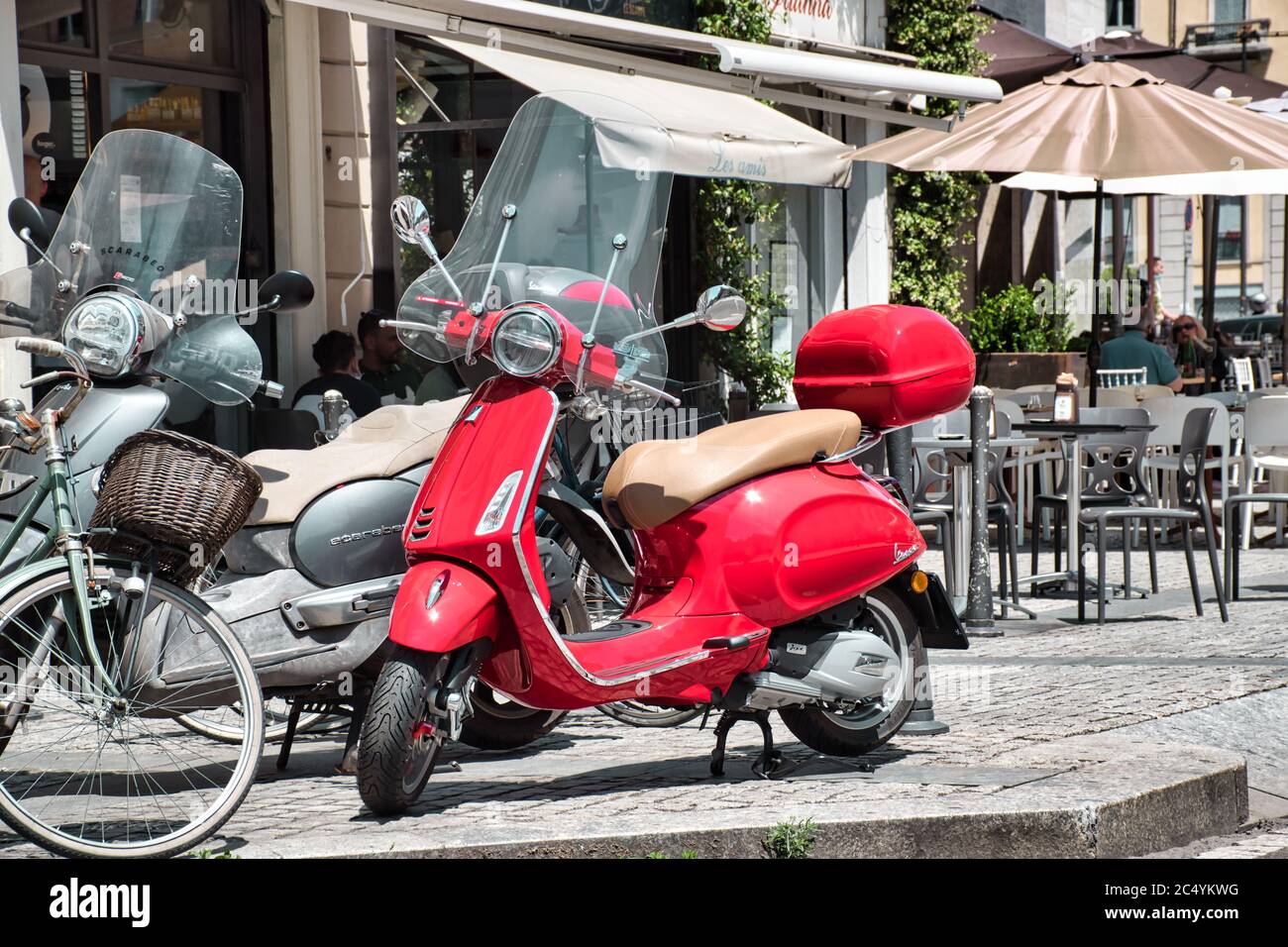 Mailand, Italien 06.29.2020: Ein gewöhnlicher Mailänder Straßenblick mit einem roten Piaggio Vespa Roller Stockfoto