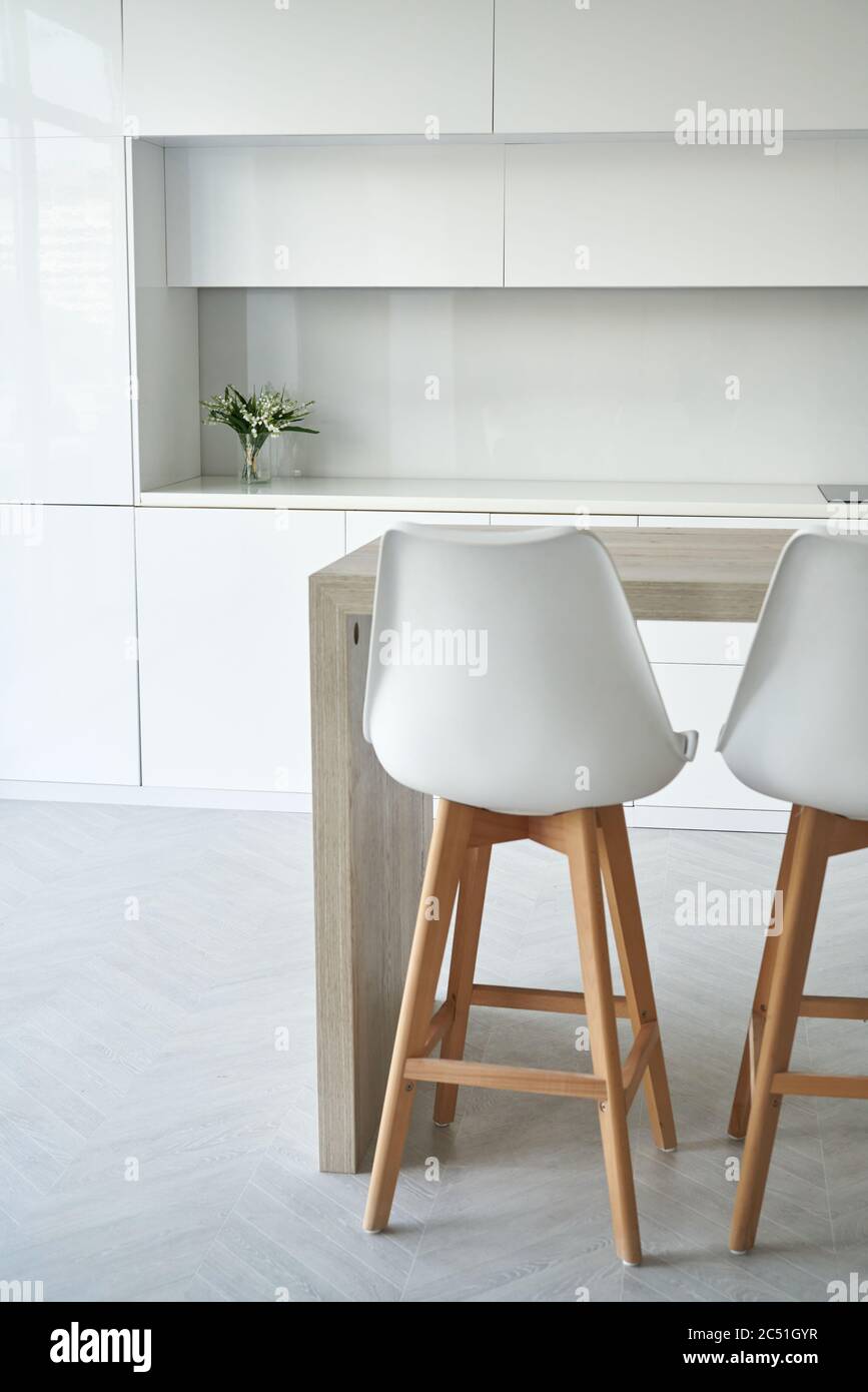 Helle Küche mit weißen Stühlen im skandinavischen Stil Stockfoto