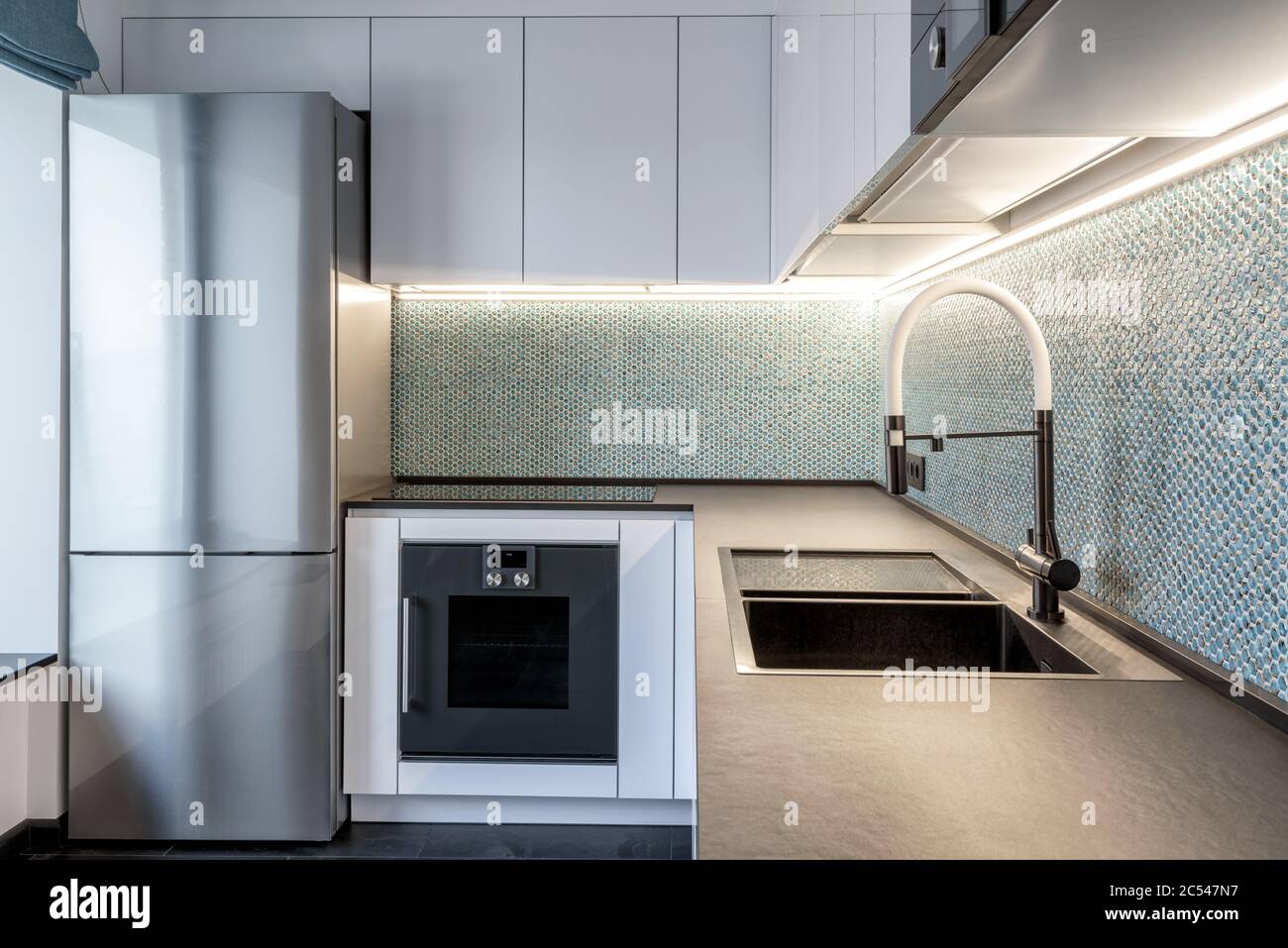 Moskau - 25. März 2018: Moderne Inneneinrichtung der Küche in einer kleinen Wohnung. Perlmutt feine Fliesen in weißen Innenarchitektur der Küche. Minimalistischer Stil o Stockfoto