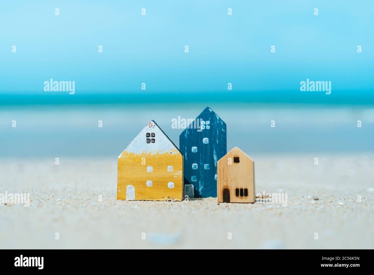Modell eines kleinen Hauses auf Sand mit Natur Strand Hintergrund. Traum-Leben-Konzept. Stockfoto