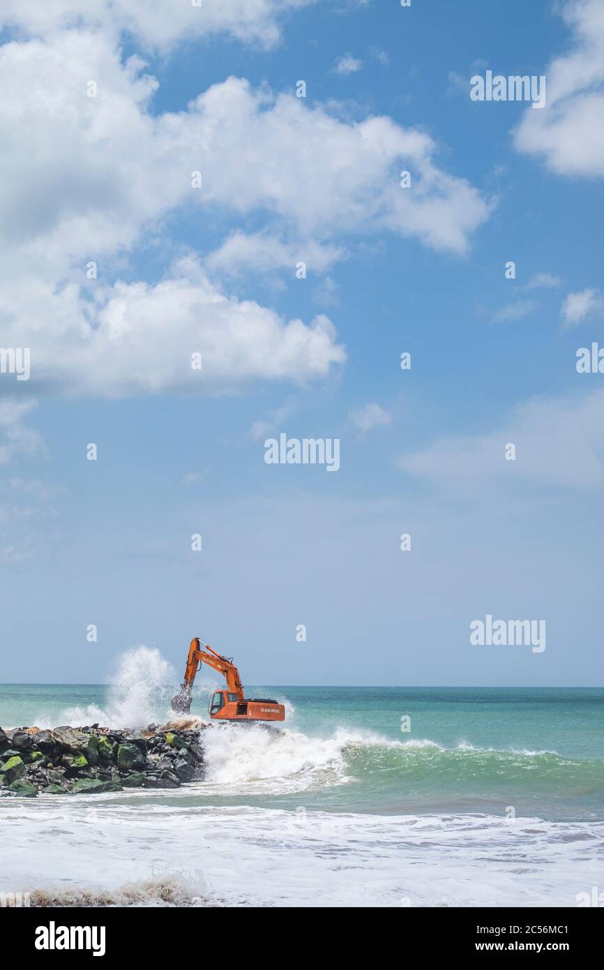 Bagger auf einem Felsbrecher an der Küste von Sri Lanka Stockfoto